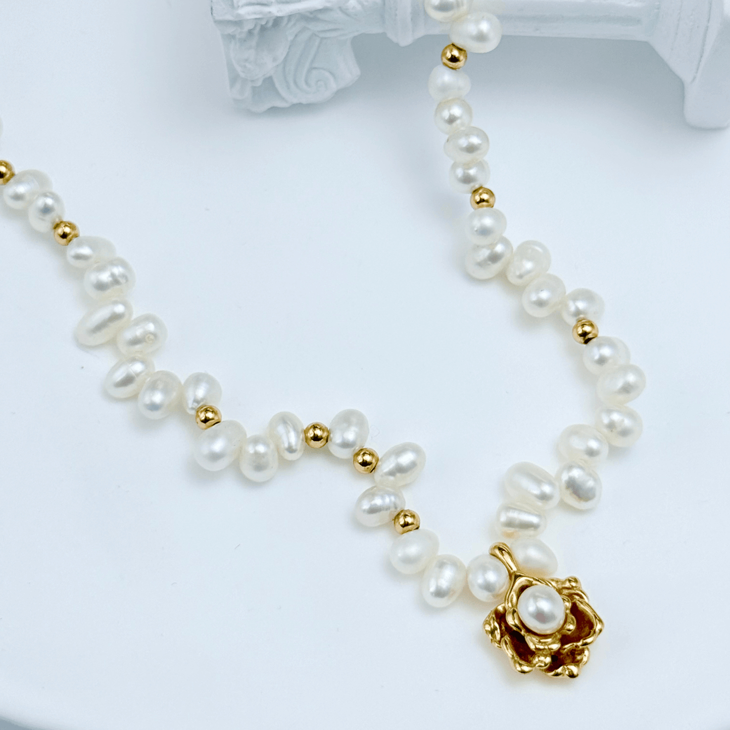 Elegant Camellia pearl necklace featuring natural baroque pearls and a sculpted gold bloom design
