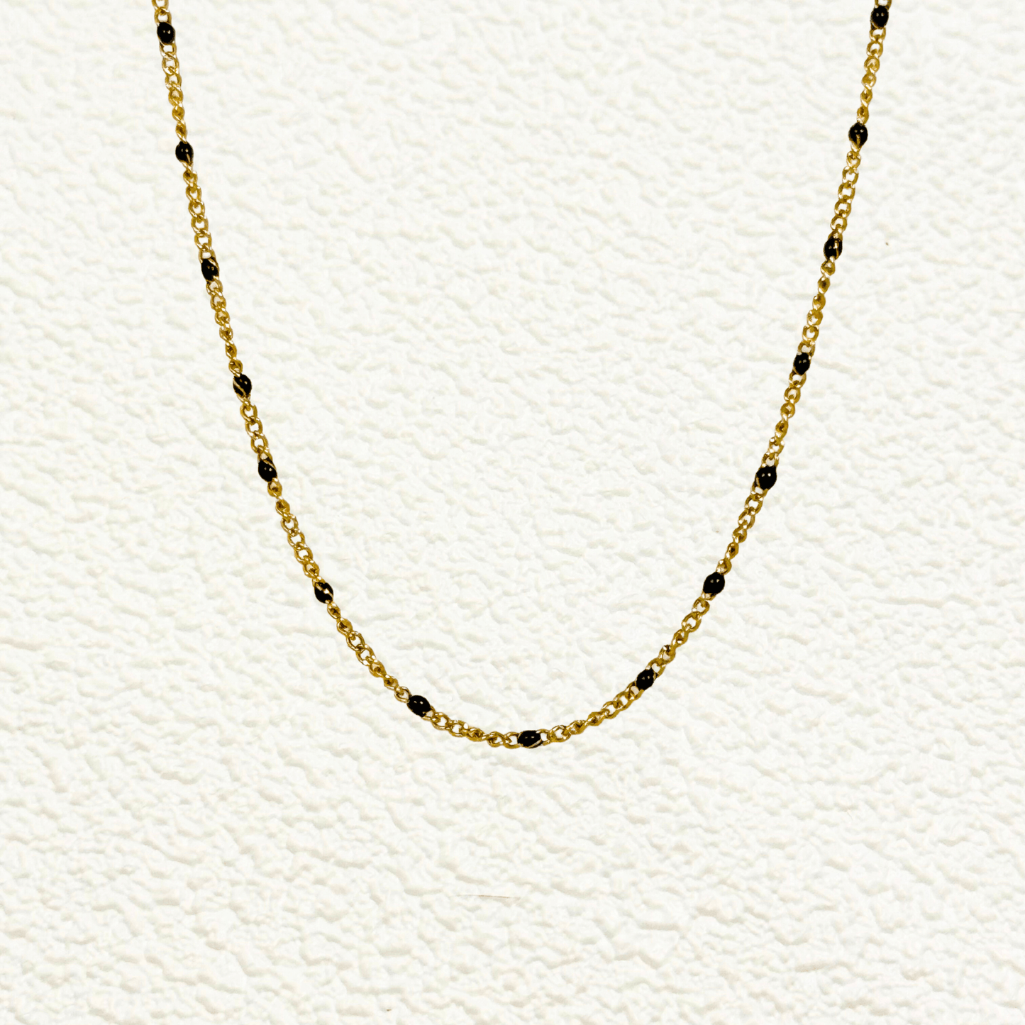 PVD gold stainless steel chain with black enamel dot accents, versatile as necklace, bracelet, or anklet