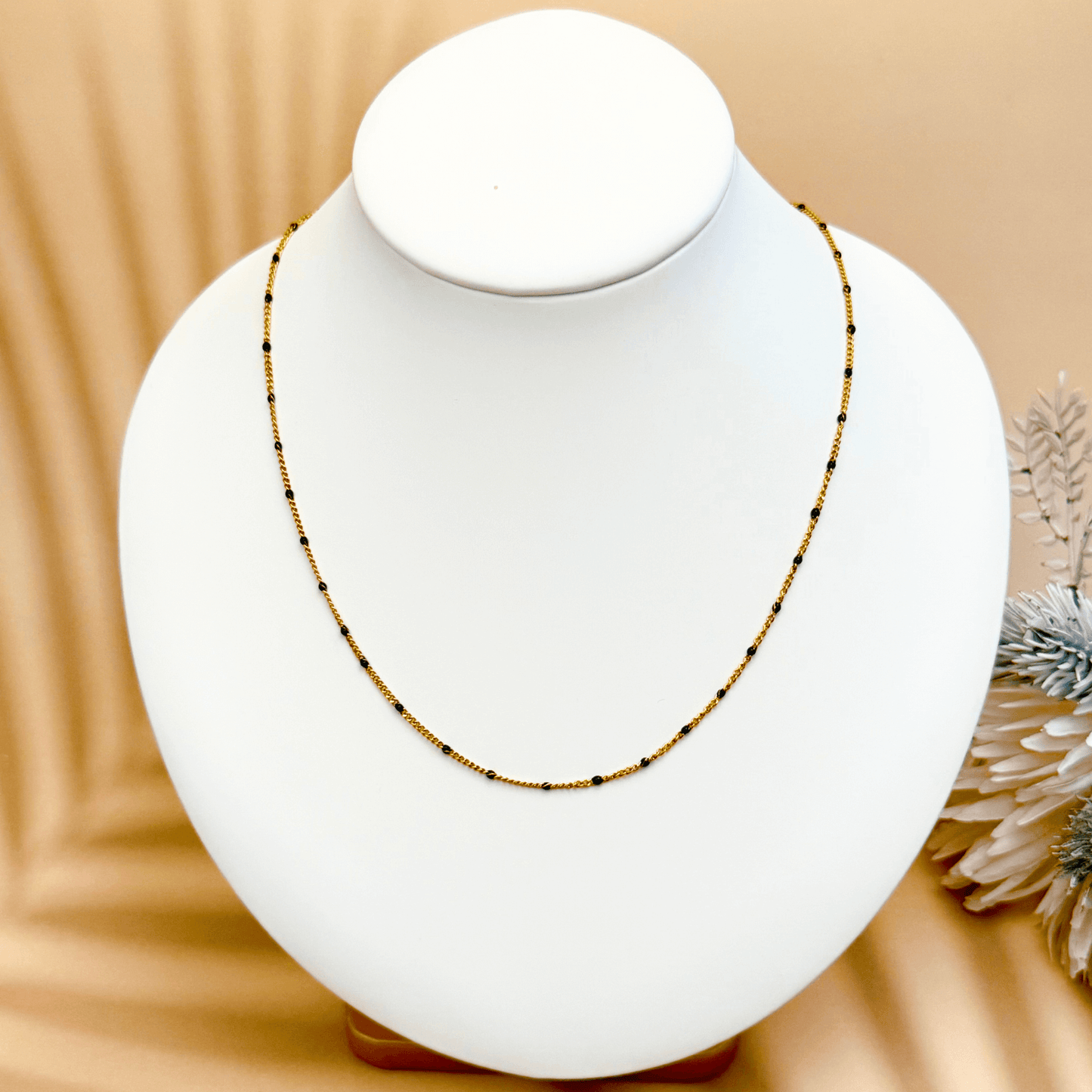 PVD gold stainless steel chain with black enamel dot accents, versatile as necklace, bracelet, or anklet