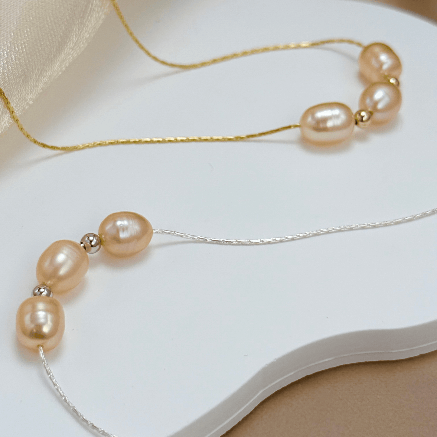 Blush pink freshwater pearl necklace with three pearls on a fine chain, available in gold filled and sterling silver options.