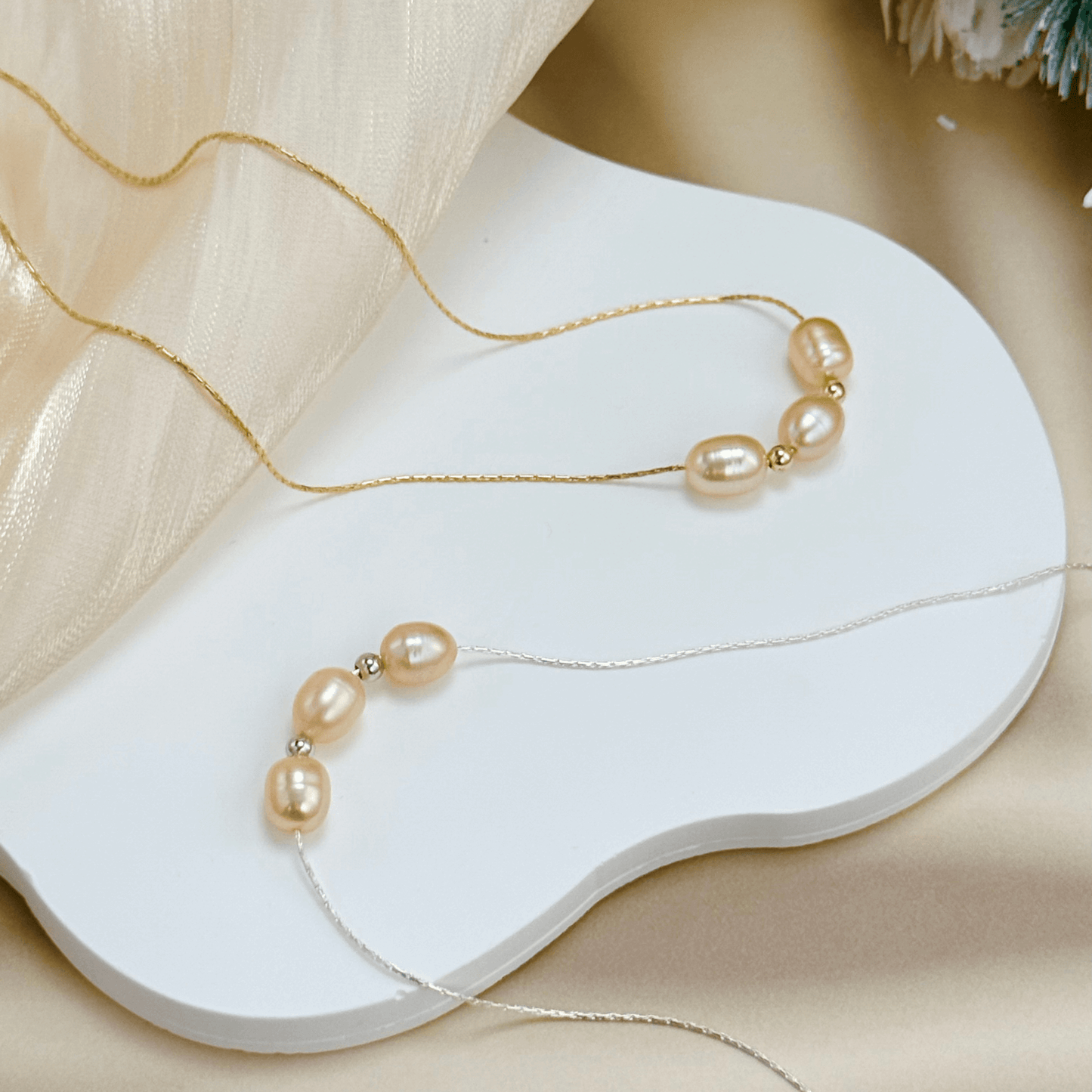 Blush pink freshwater pearl necklace with three pearls on a fine chain, available in gold filled and sterling silver options.