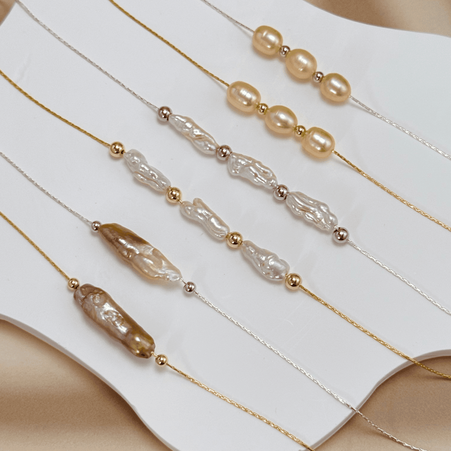 Blush pink freshwater pearl necklace with three pearls on a fine chain, available in gold filled and sterling silver options.