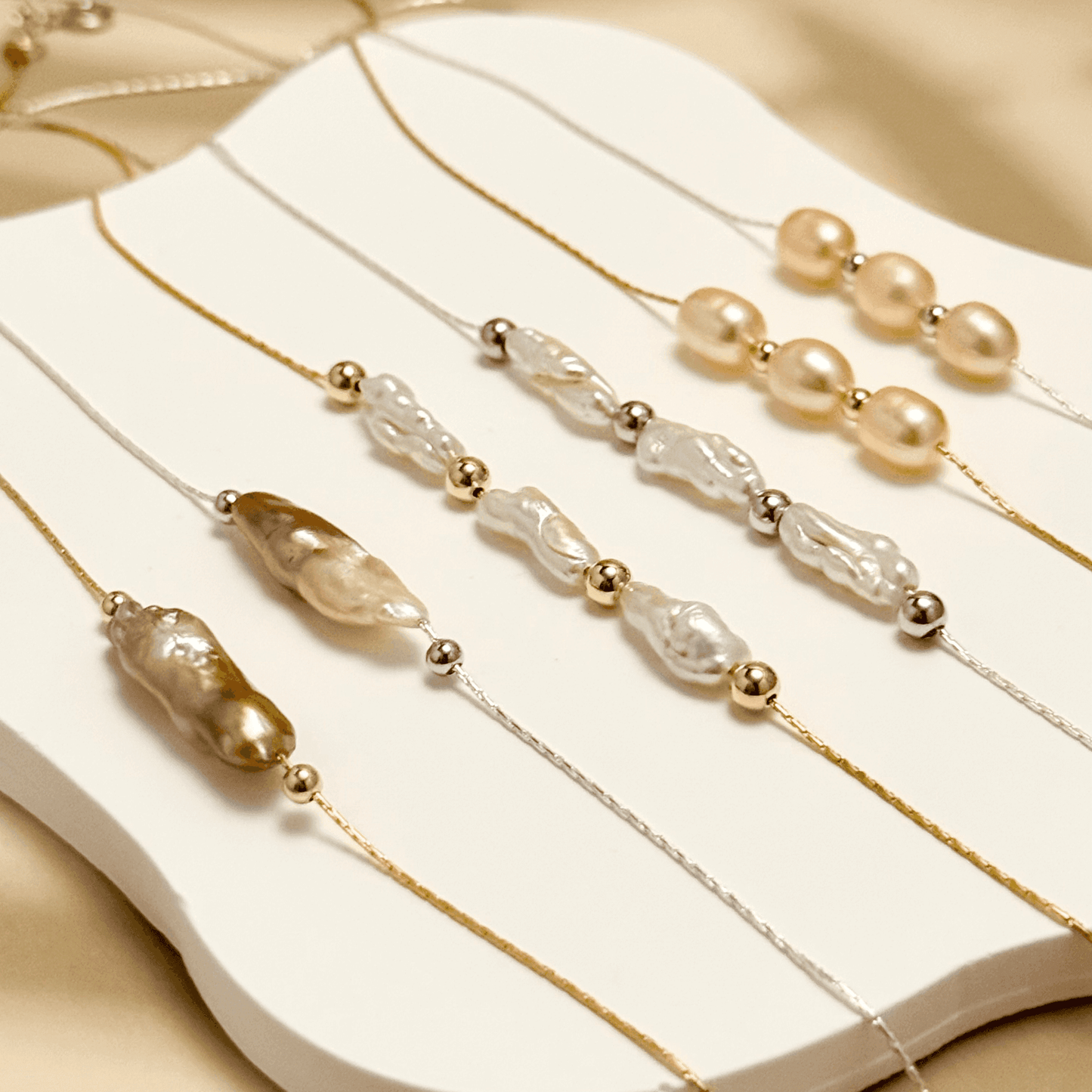 Blush pink freshwater pearl necklace with three pearls on a fine chain, available in gold filled and sterling silver options.