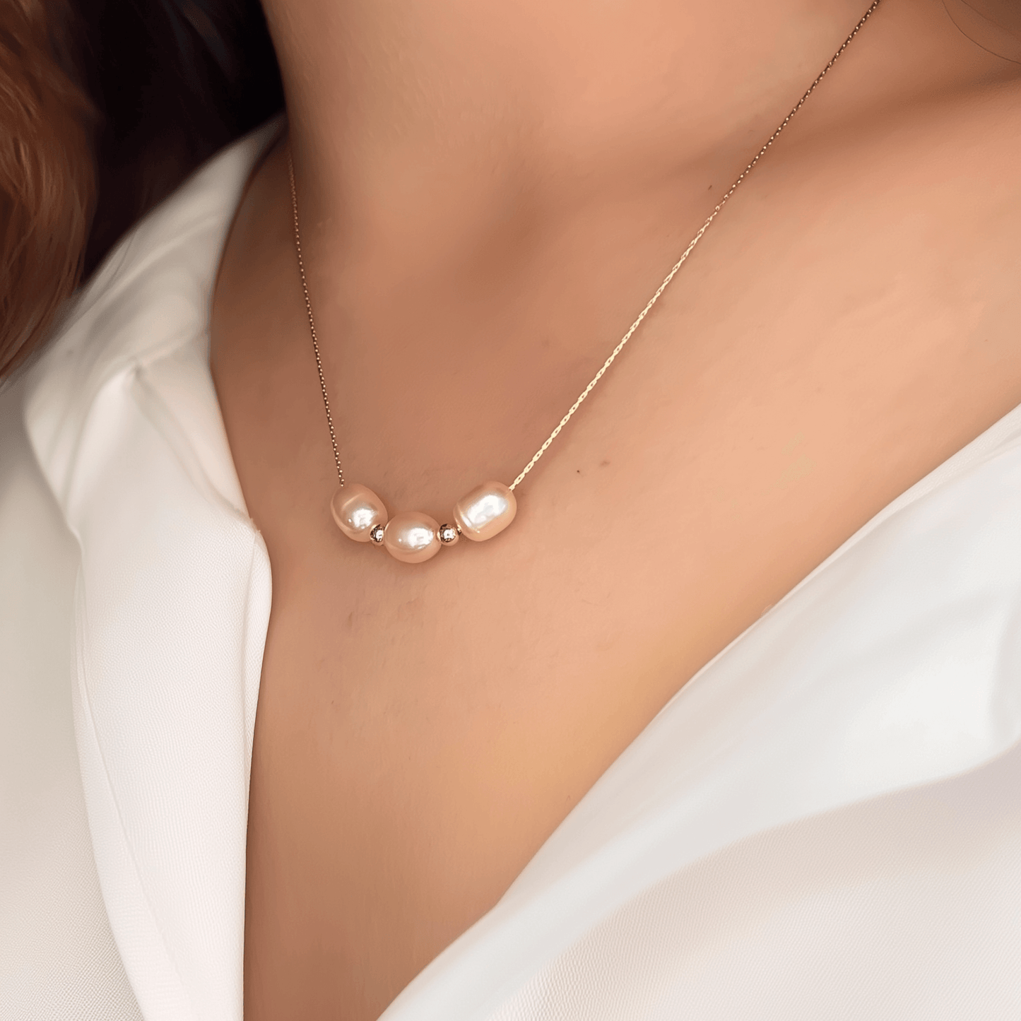 Blush pink freshwater pearl necklace with three pearls on a fine chain, available in gold filled and sterling silver options.