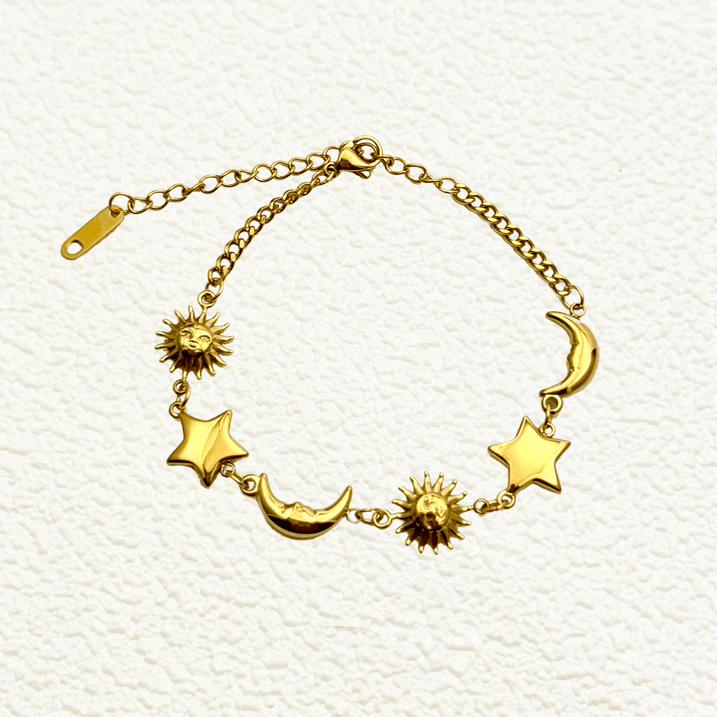 Waterproof gold celestial charm bracelet featuring sun, star, and crescent moon charms, made from PVD gold-plated stainless steel with an adjustable chain
