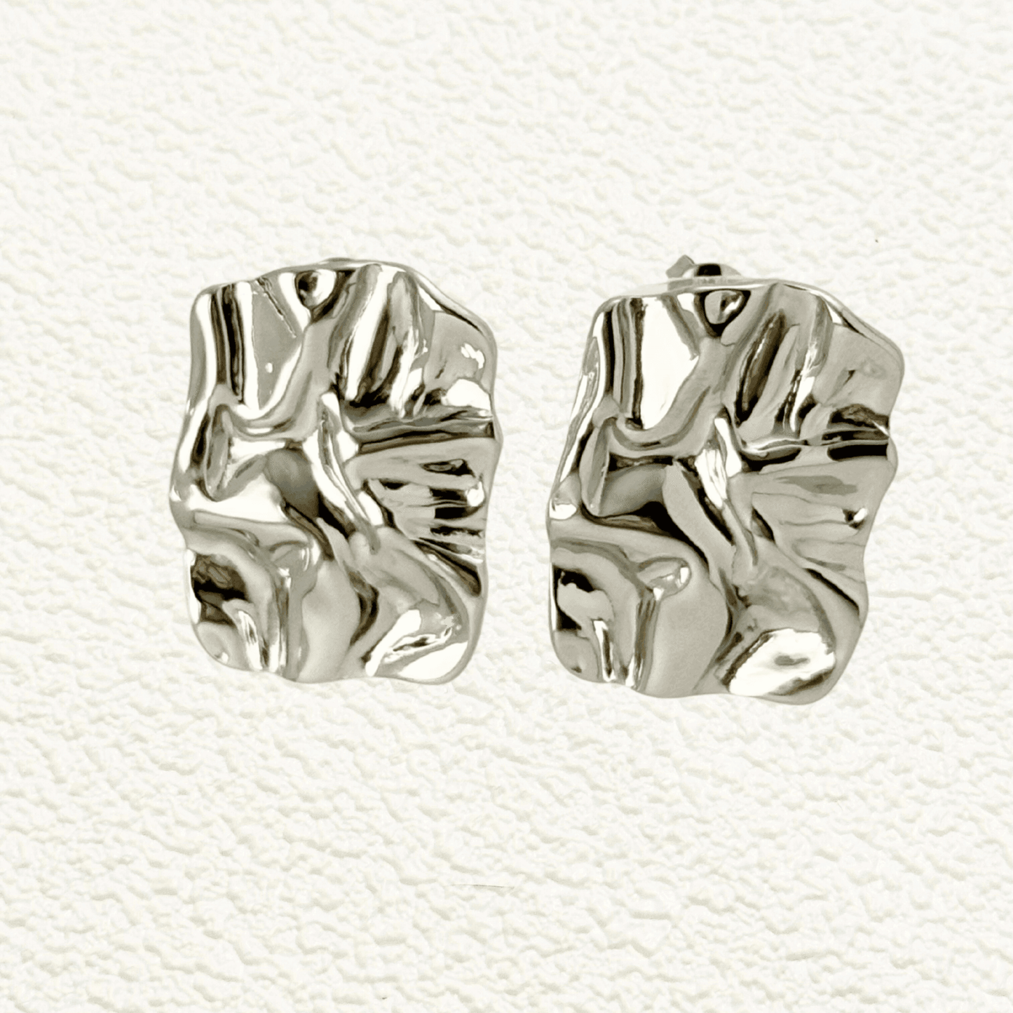 Gold and silver crinkled texture stud earrings – modern statement stainless steel earrings, PVD plated, waterproof and hypoallergenic.