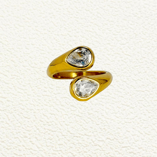 Crystal Flame Ring featuring two clear teardrop crystals set on a gold open band. Adjustable, waterproof, and tarnish-resistant for elegant daily wear.