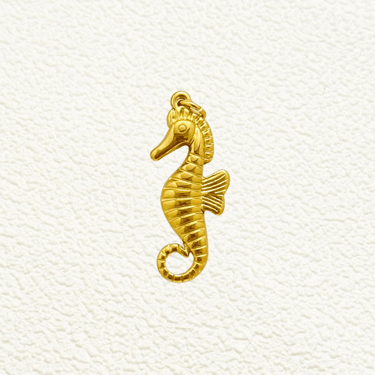 Gold Curled Fin Seahorse Charm with textured lines and raised eye detail