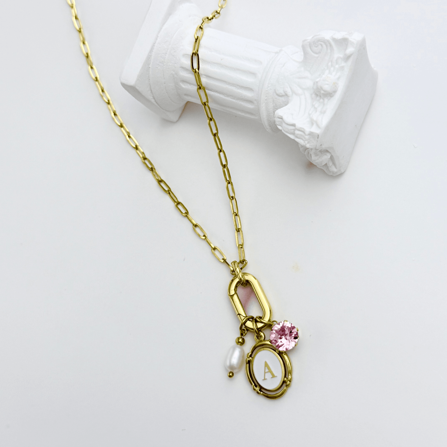 Gold openable link charm necklace with pink Swarovski birthstone and freshwater pearl on waterproof chain, customisable to add any charms