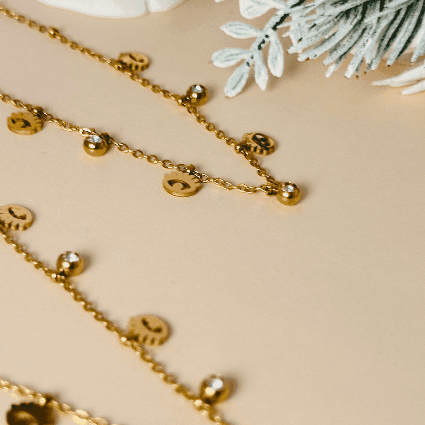 Dainty gold-plated evil eye necklace or bracelet with zircon accents, waterproof and hypoallergenic.