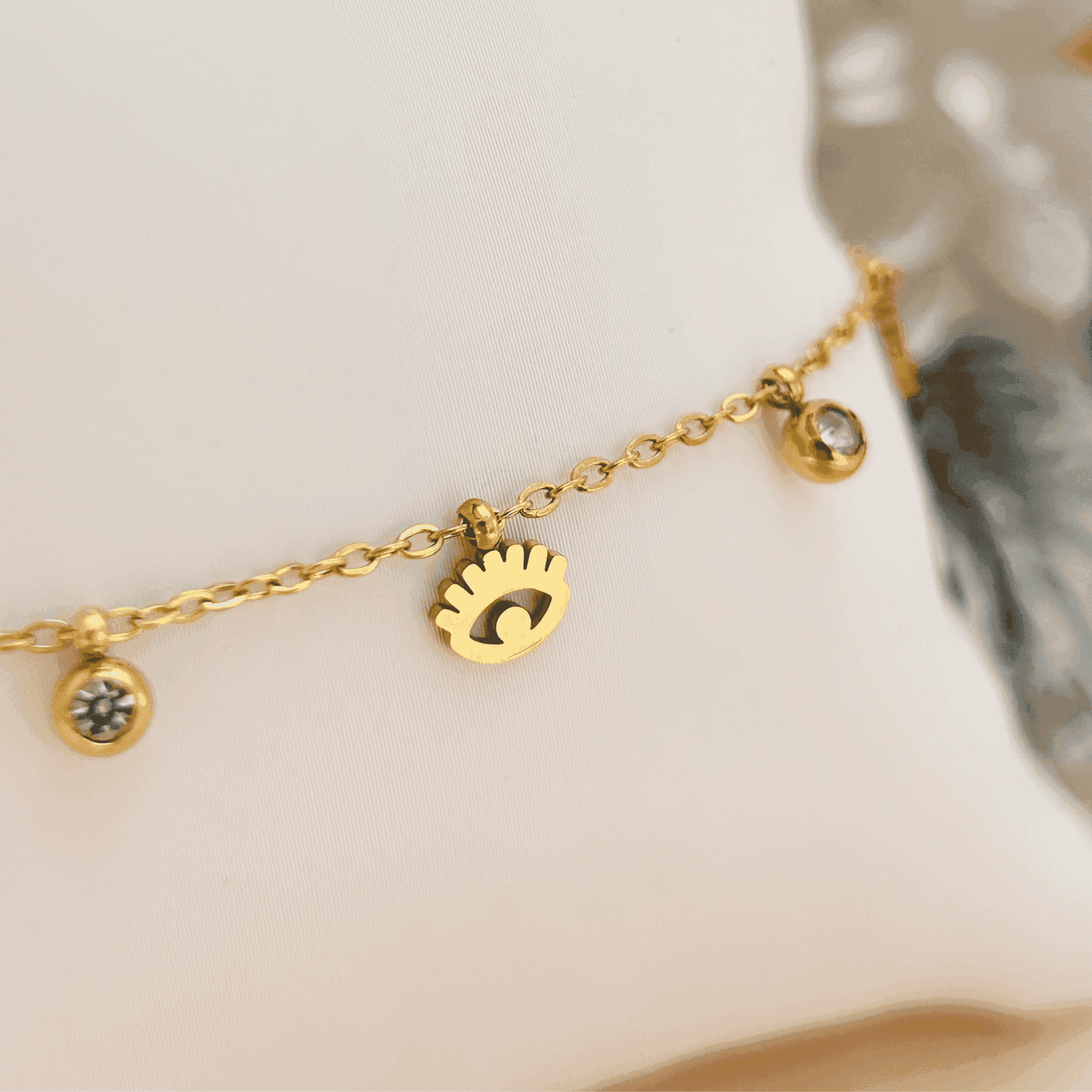 Dainty gold-plated evil eye necklace or bracelet with zircon accents, waterproof and hypoallergenic.