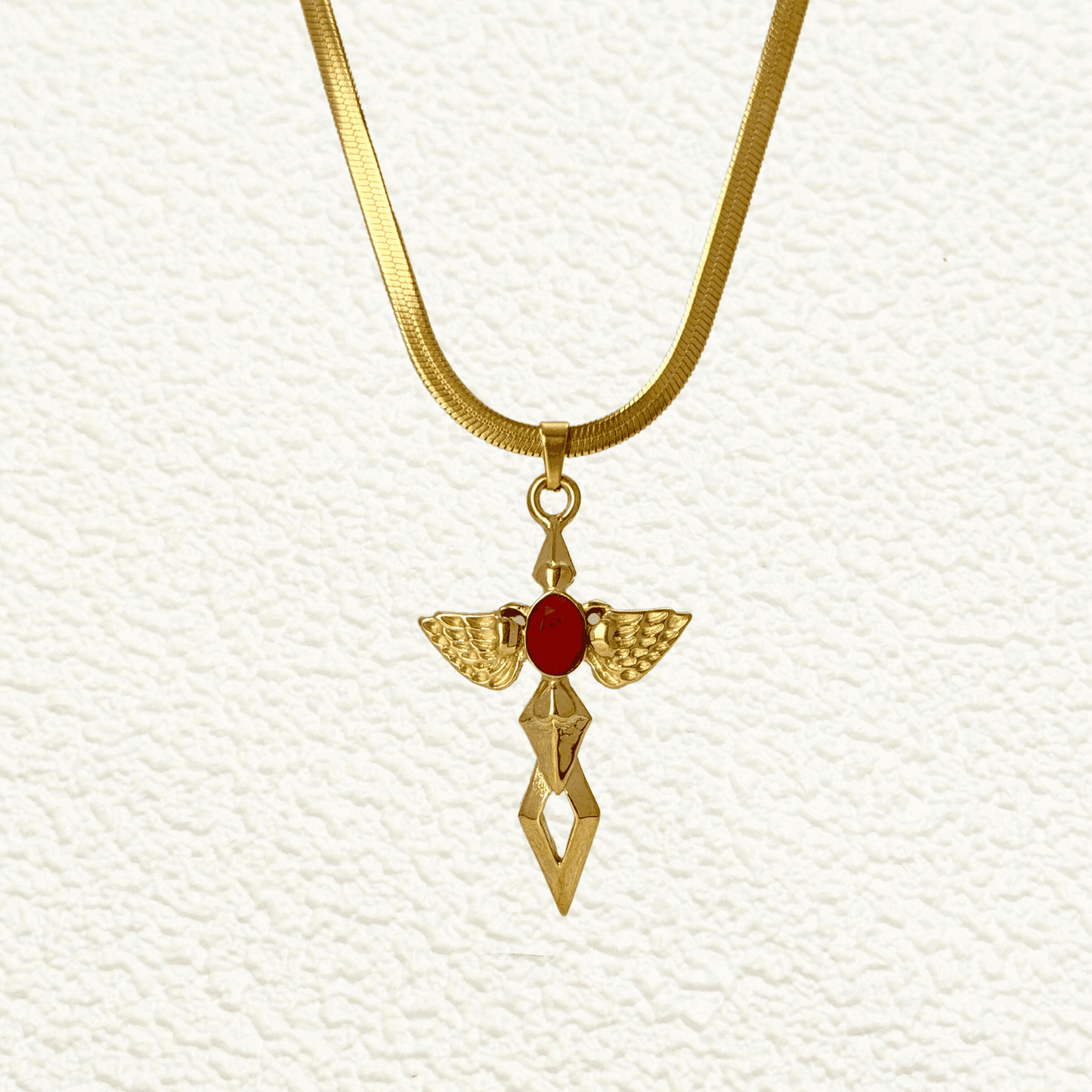 Gold angel wing cross pendant necklace with red zircon stone – spiritual gothic necklace with celestial symbolism