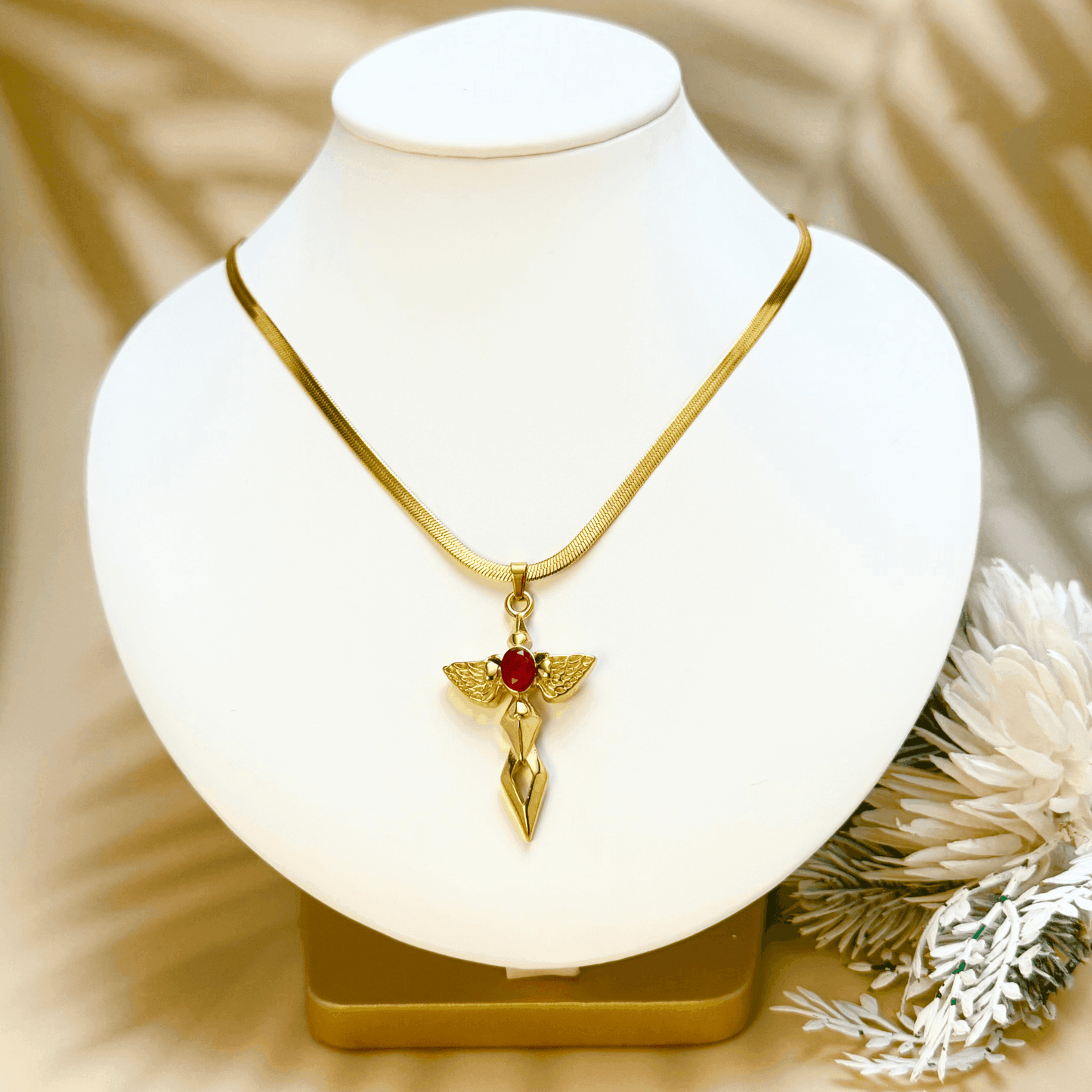 Gold angel wing cross pendant necklace with red zircon stone – spiritual gothic necklace with celestial symbolism