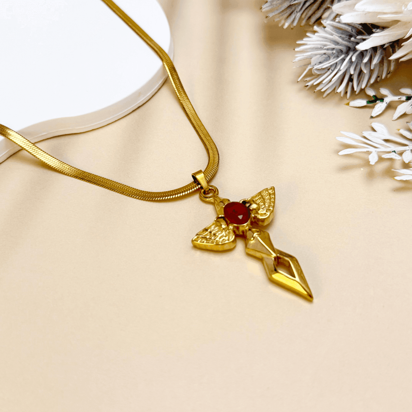 Gold angel wing cross pendant necklace with red zircon stone – spiritual gothic necklace with celestial symbolism