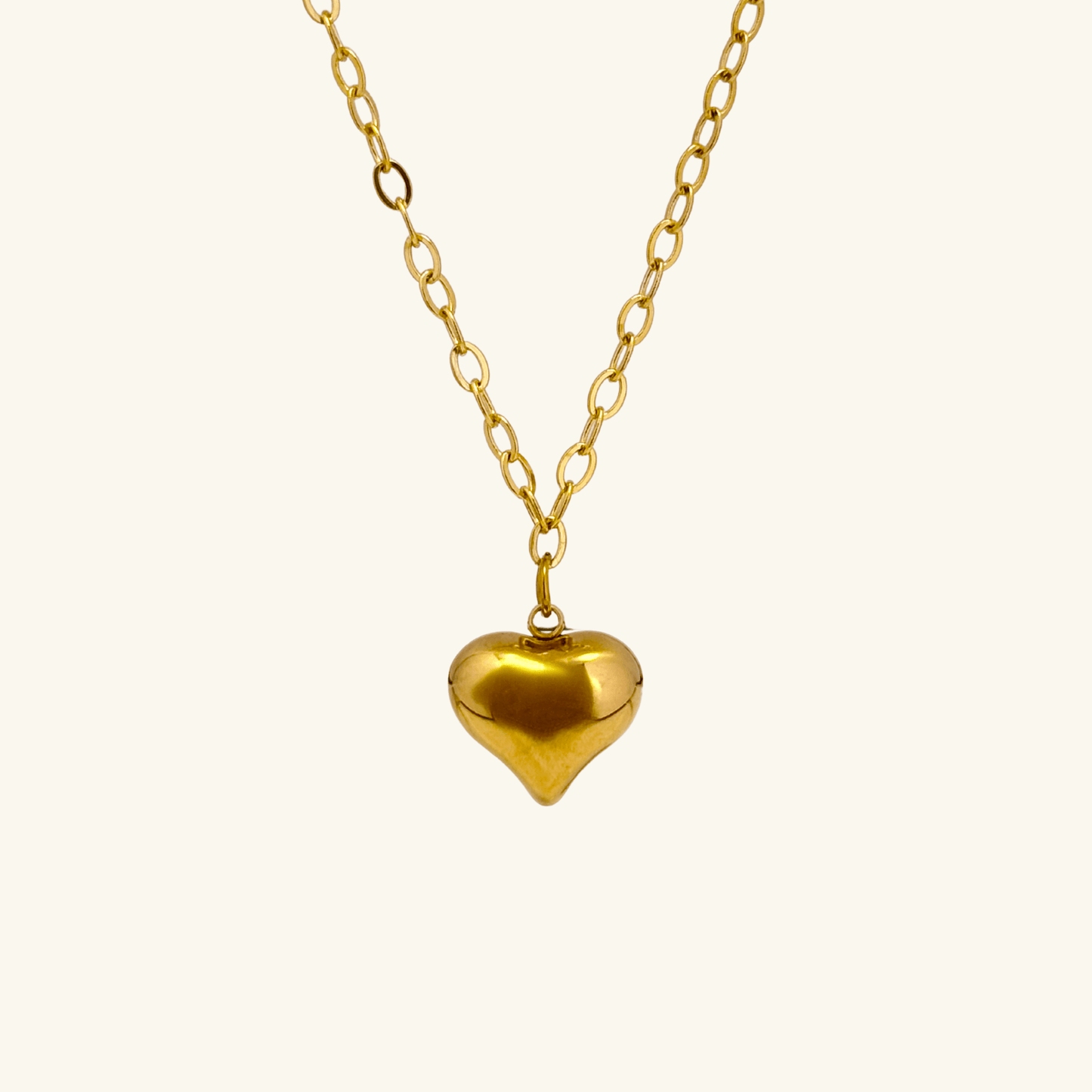 Gold chunky heart pendant necklace on model, waterproof and bold statement design