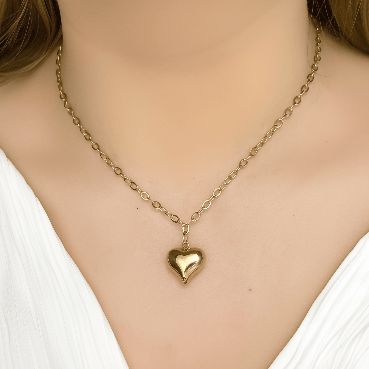 Gold chunky heart pendant necklace on model, waterproof and bold statement design