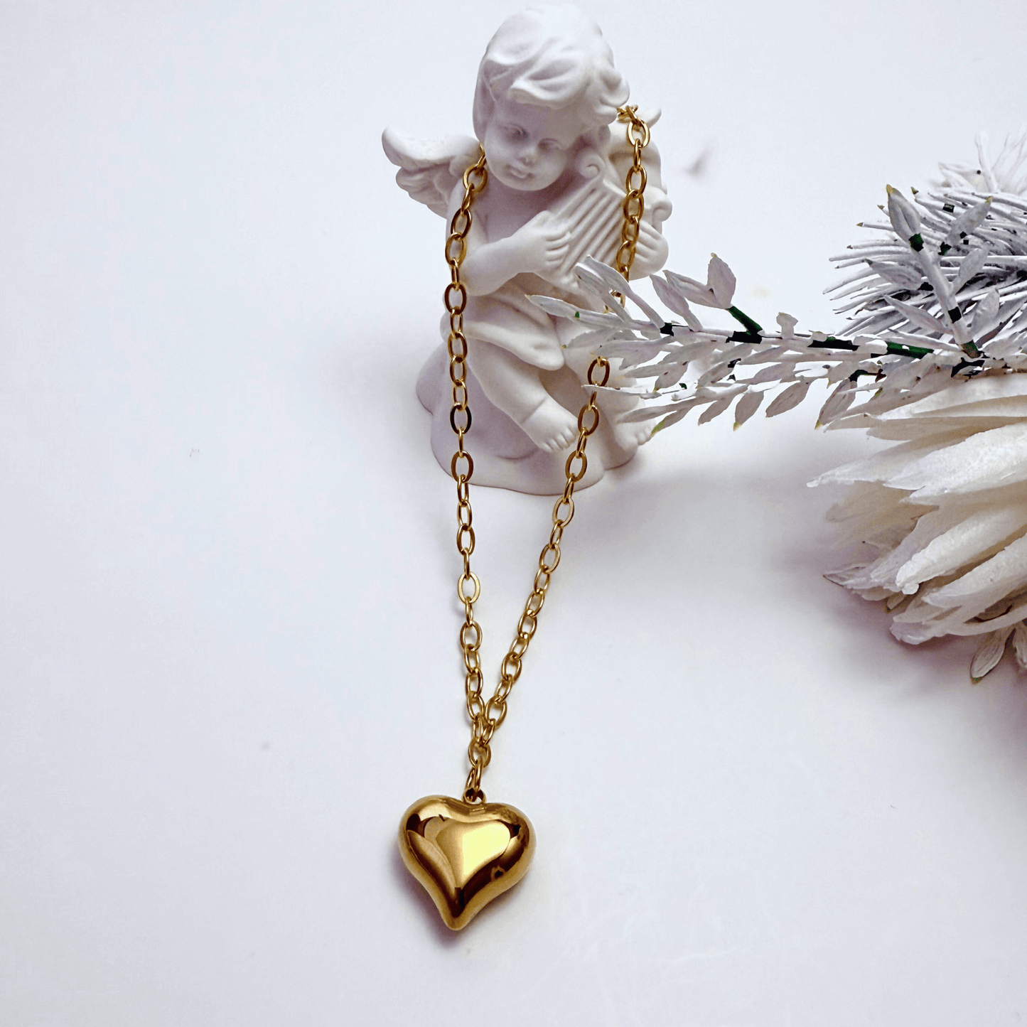 Gold chunky heart pendant necklace on model, waterproof and bold statement design