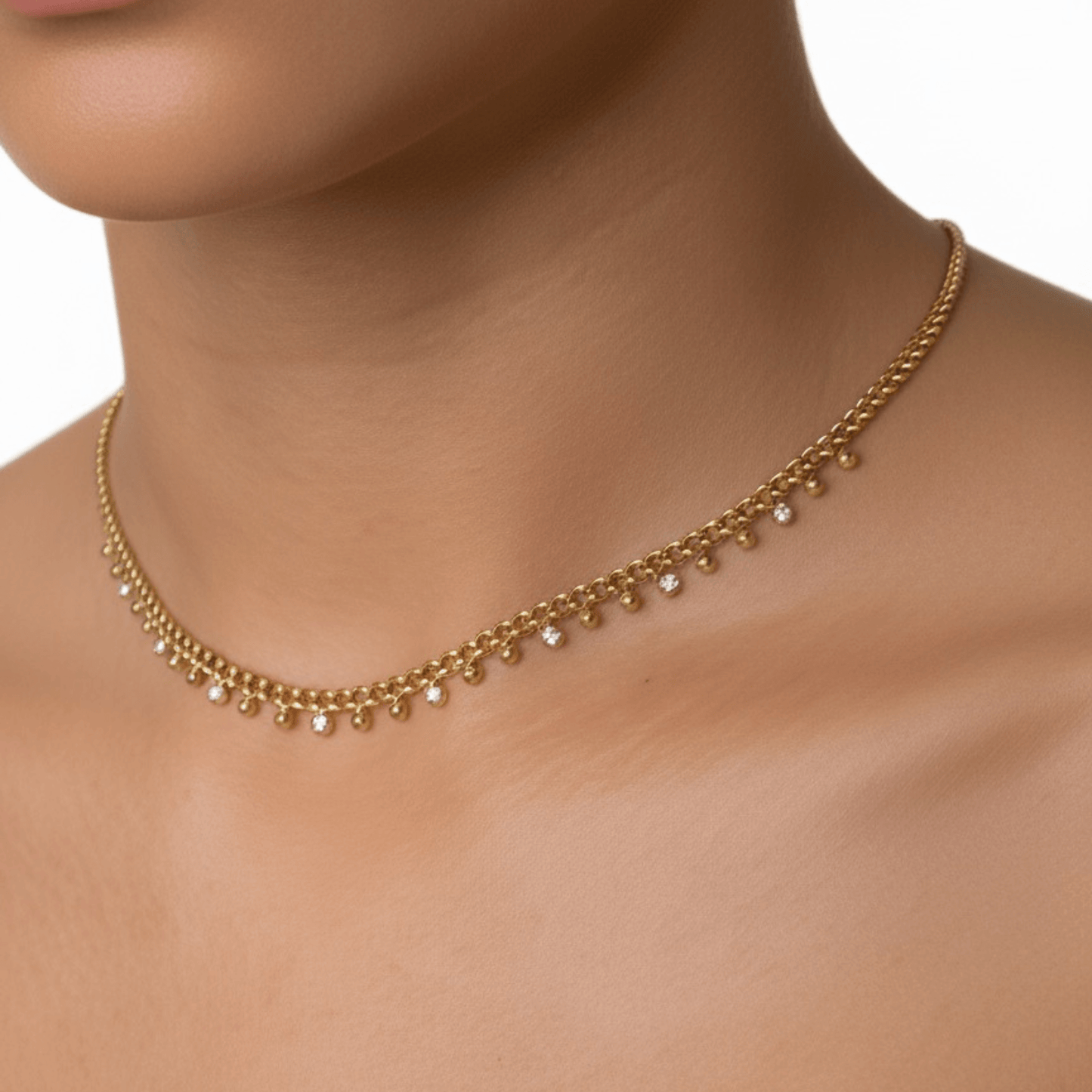 Elegant gold necklace featuring a cable chain adorned with zircon charms and gold beads, crafted from gold-plated stainless steel for a timeless and sophisticated look.