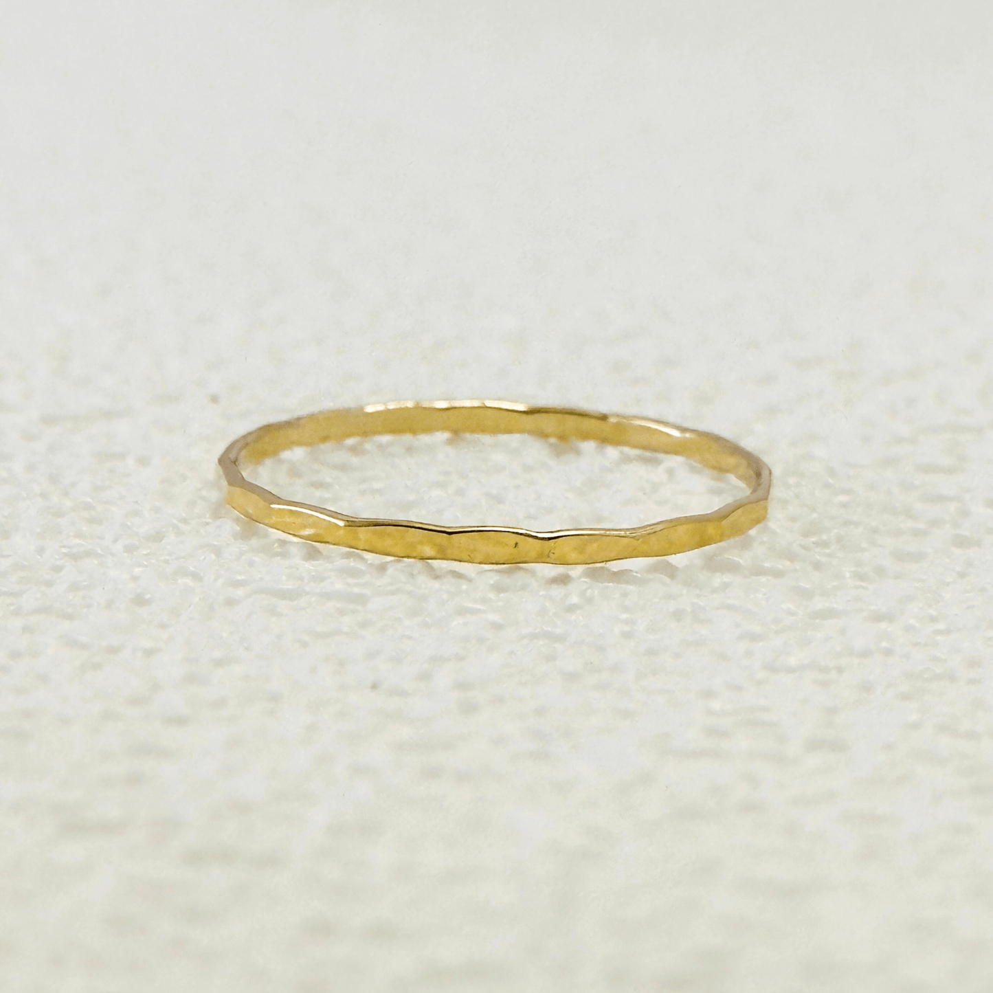 gold filled stackable ring with a textured hammered finish, minimalist and elegant design.
