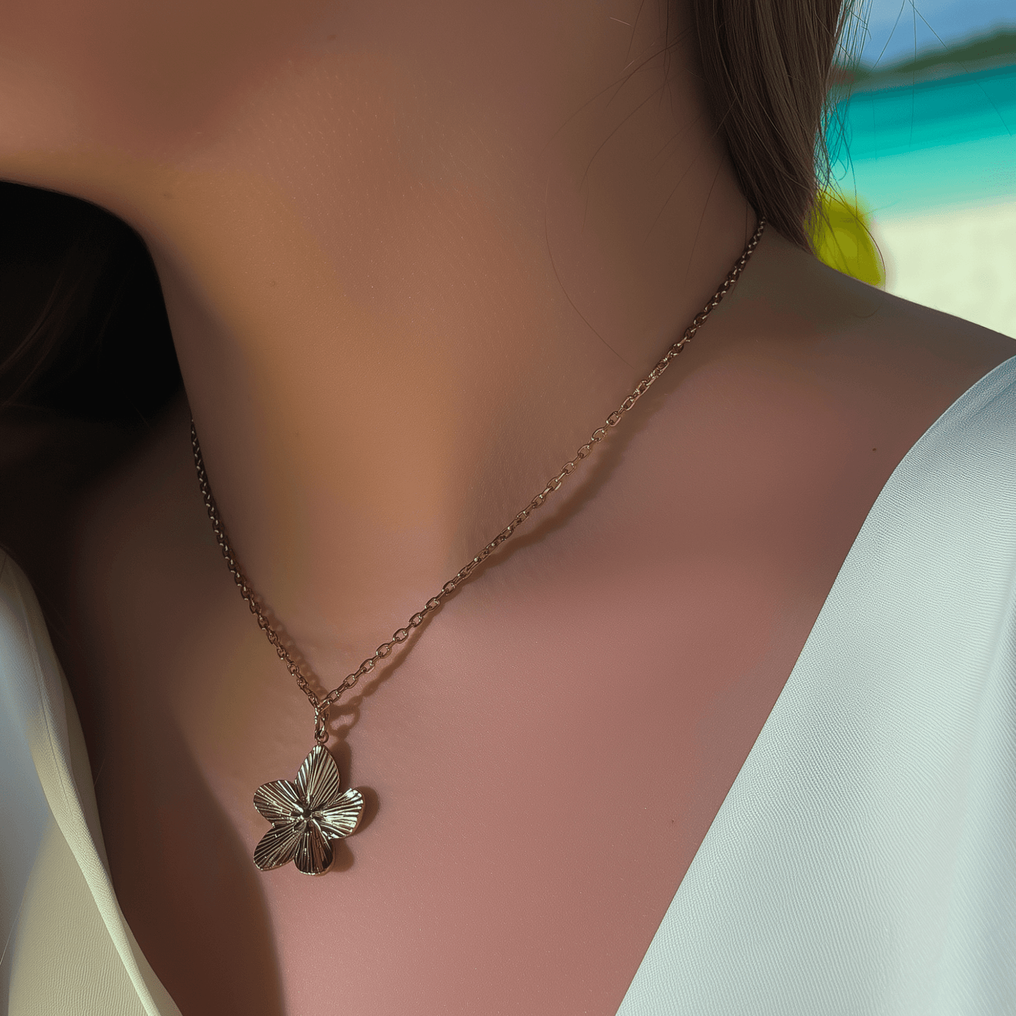 Gold flower pendant necklace on model, waterproof floral jewellery with dainty chain