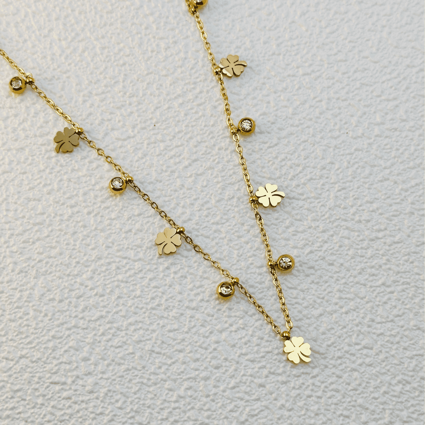 Gold four-leaf clover charm necklace with zircon accents, waterproof and tarnish-resistant