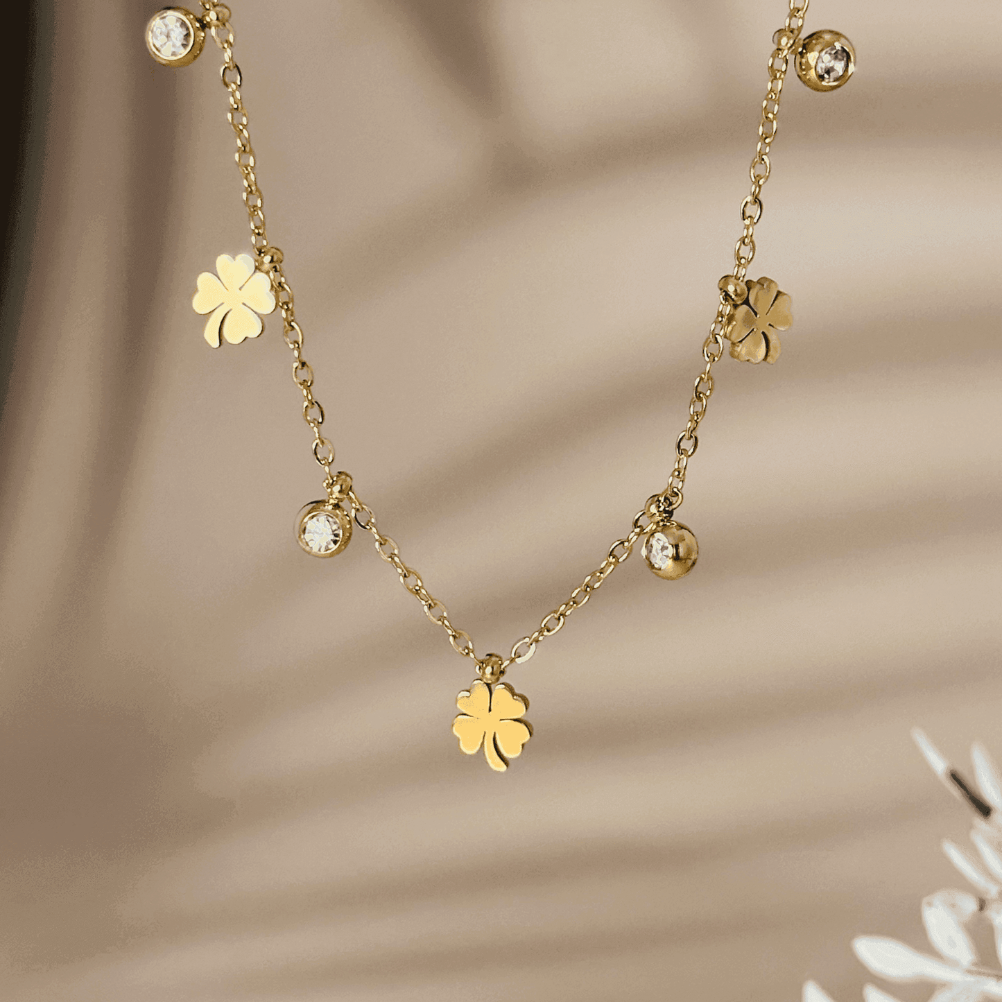 Gold four-leaf clover charm necklace or bracelet with zircon accents, waterproof and tarnish-resistant