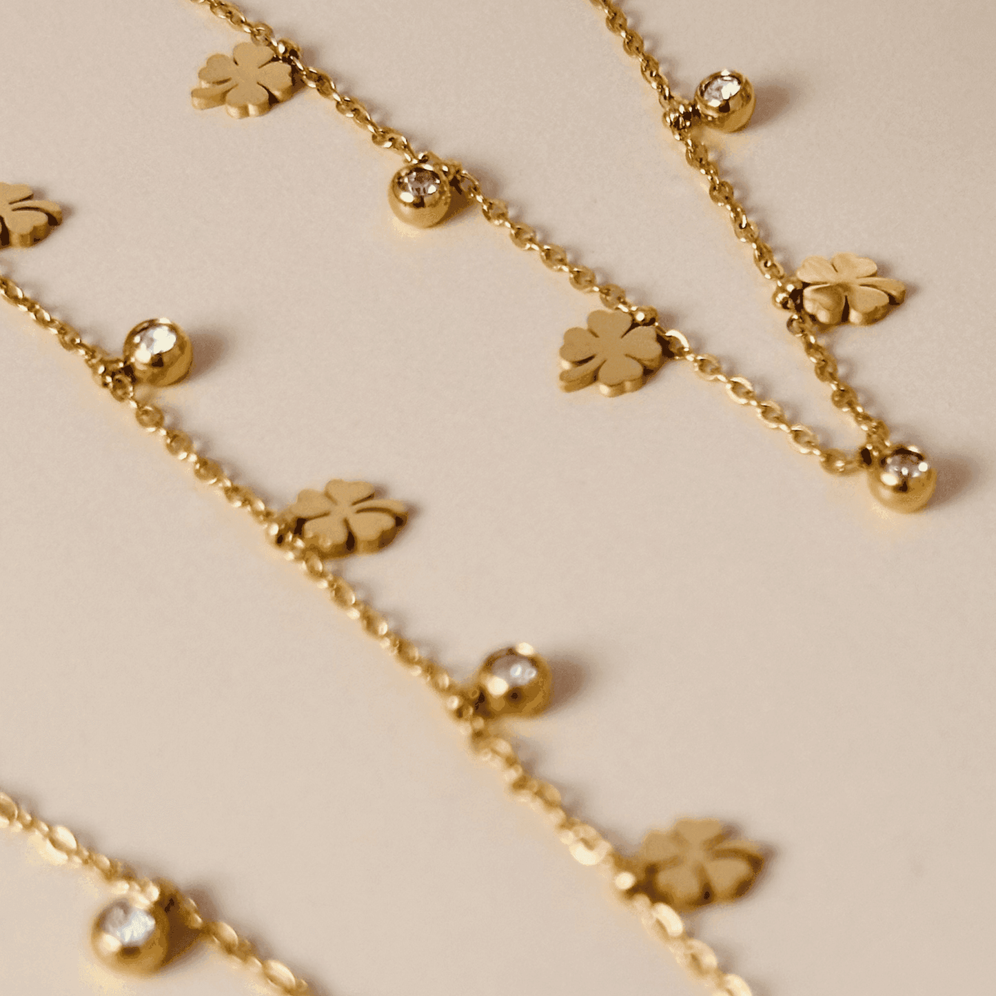 Gold four-leaf clover charm necklace or bracelet with zircon accents, waterproof and tarnish-resistant