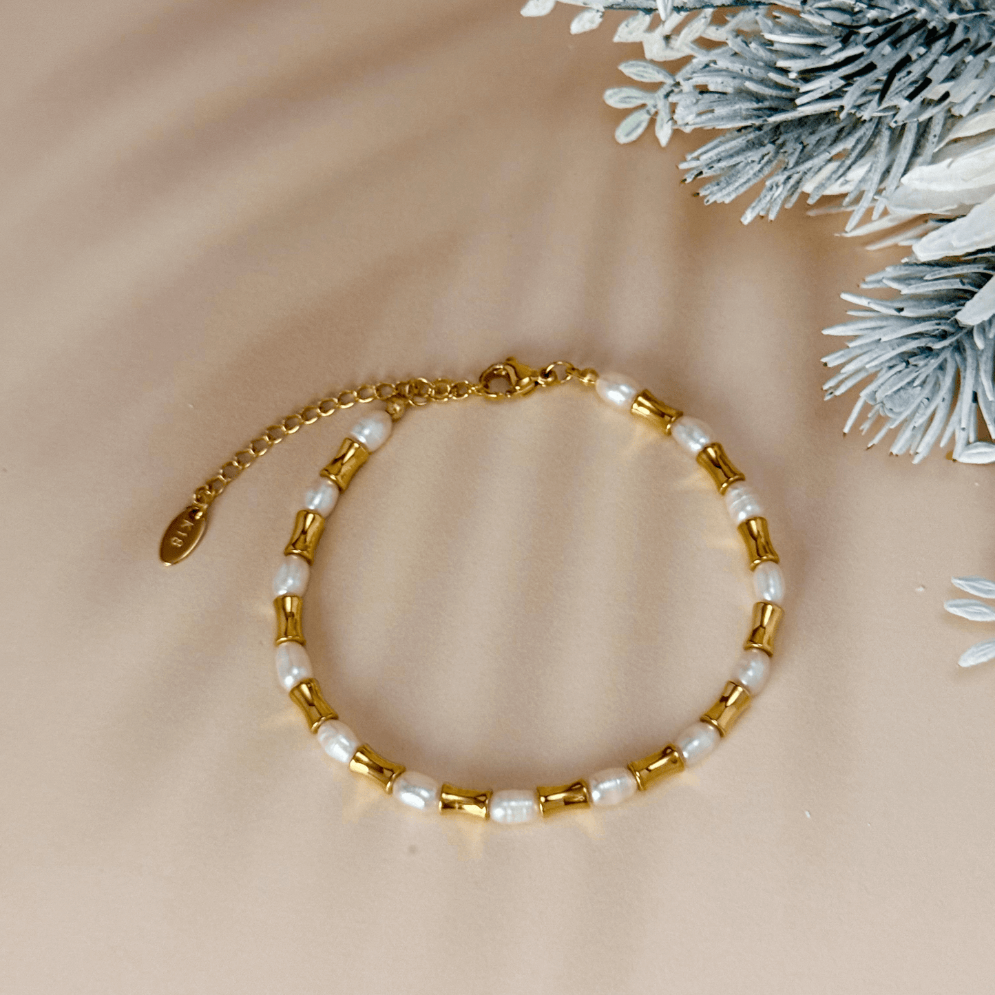 Gold and freshwater pearl bracelet with tube beads, waterproof and minimalist design.