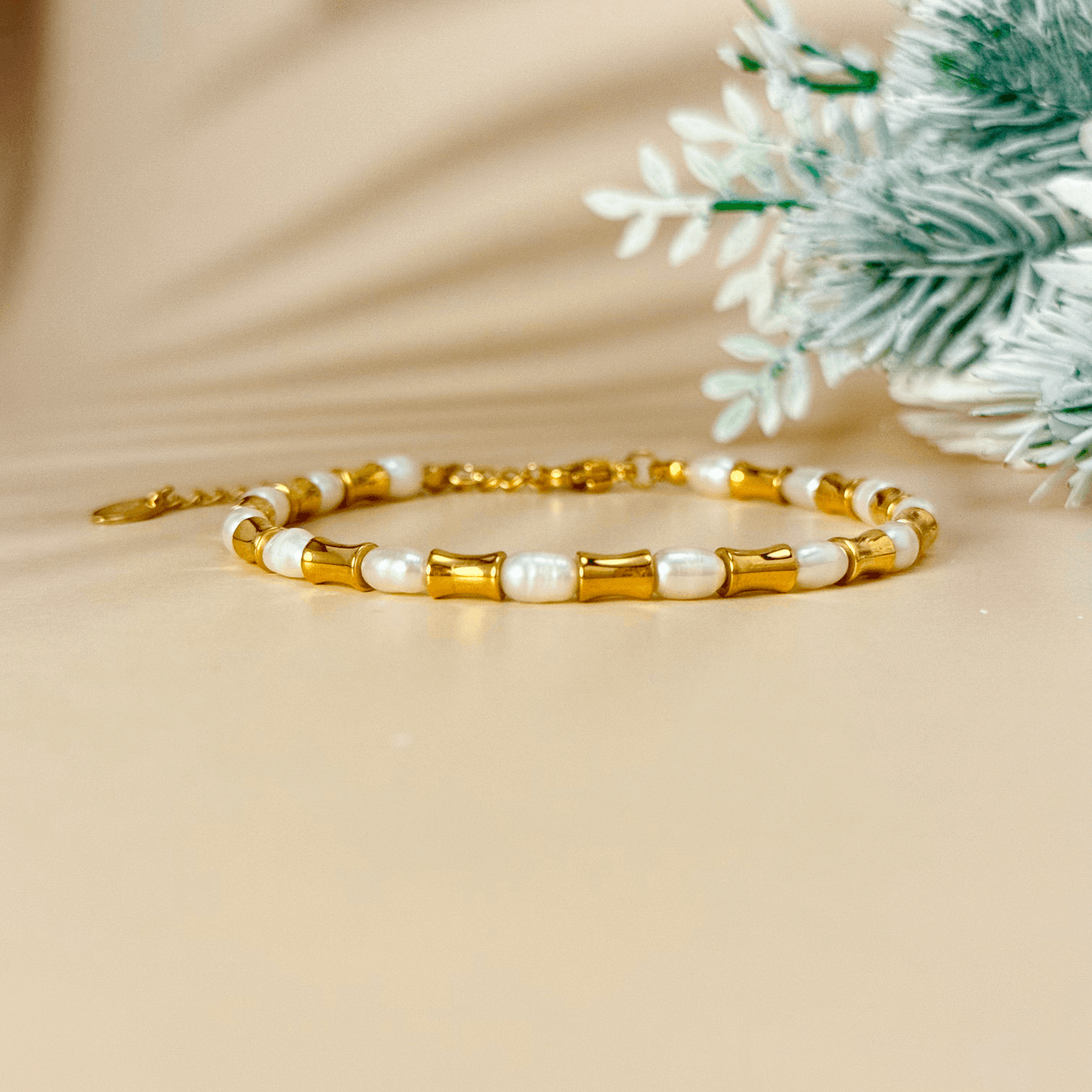 Gold and freshwater pearl bracelet with tube beads, waterproof and minimalist design.