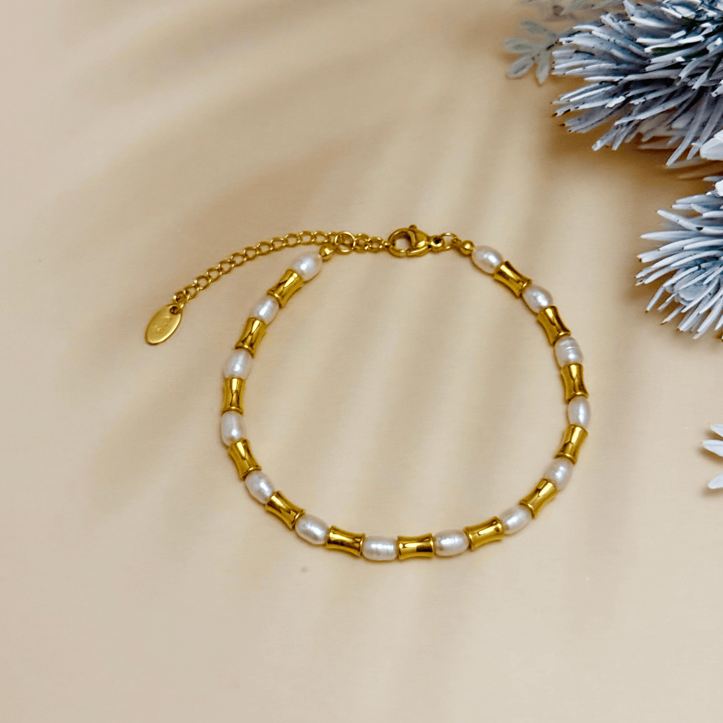 Gold and freshwater pearl bracelet with tube beads, waterproof and minimalist design.