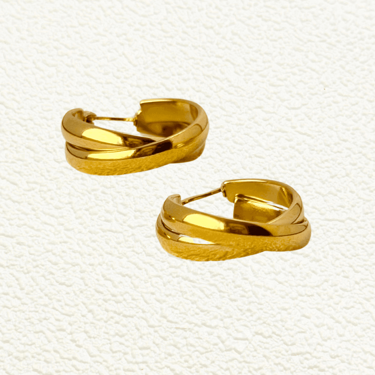 Gold interwoven dome hoop earrings with sculptural design and polished finish, stainless steel with PVD gold plating, minimalist waterproof jewellery.