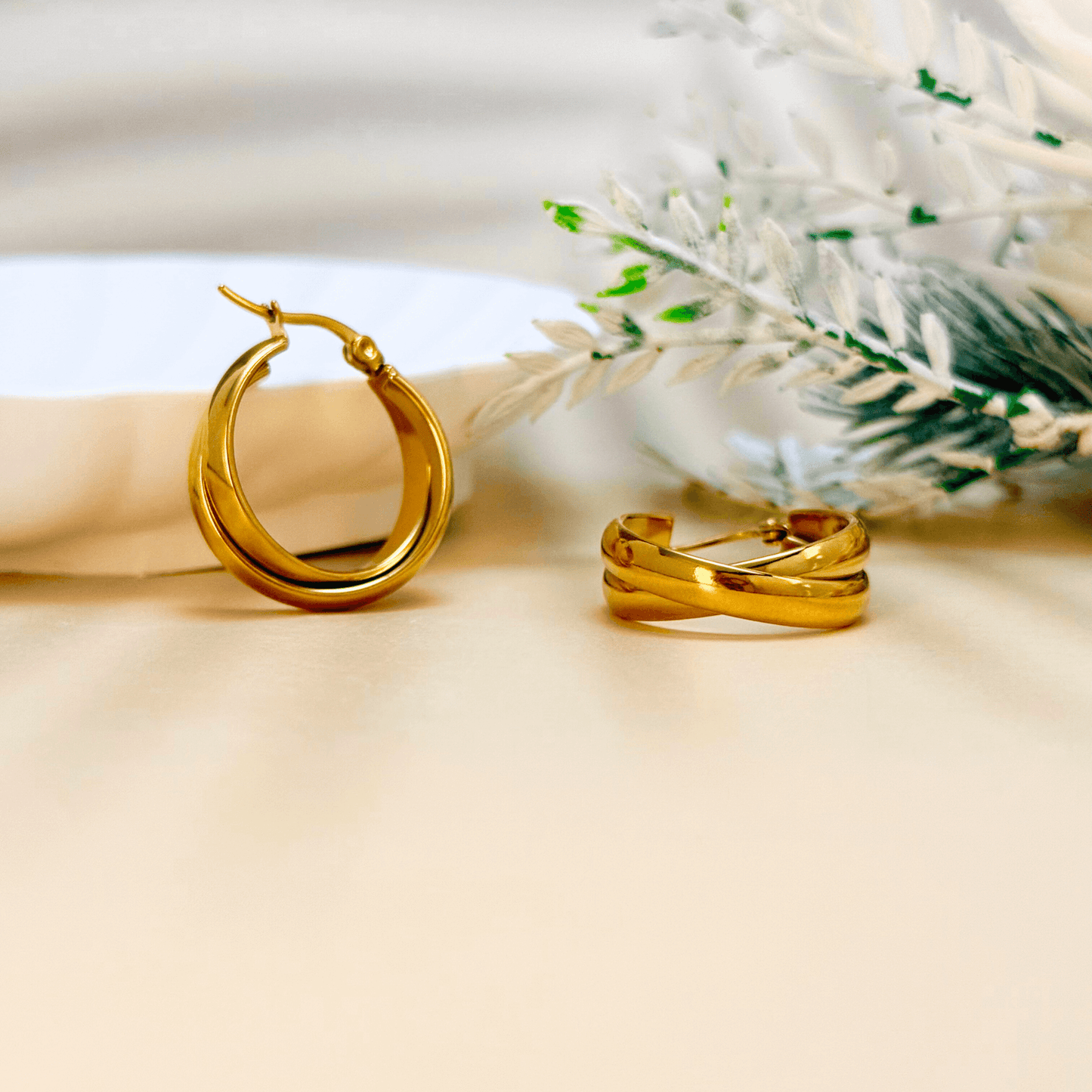 Gold interwoven dome hoop earrings with sculptural design and polished finish, stainless steel with PVD gold plating, minimalist waterproof jewellery.