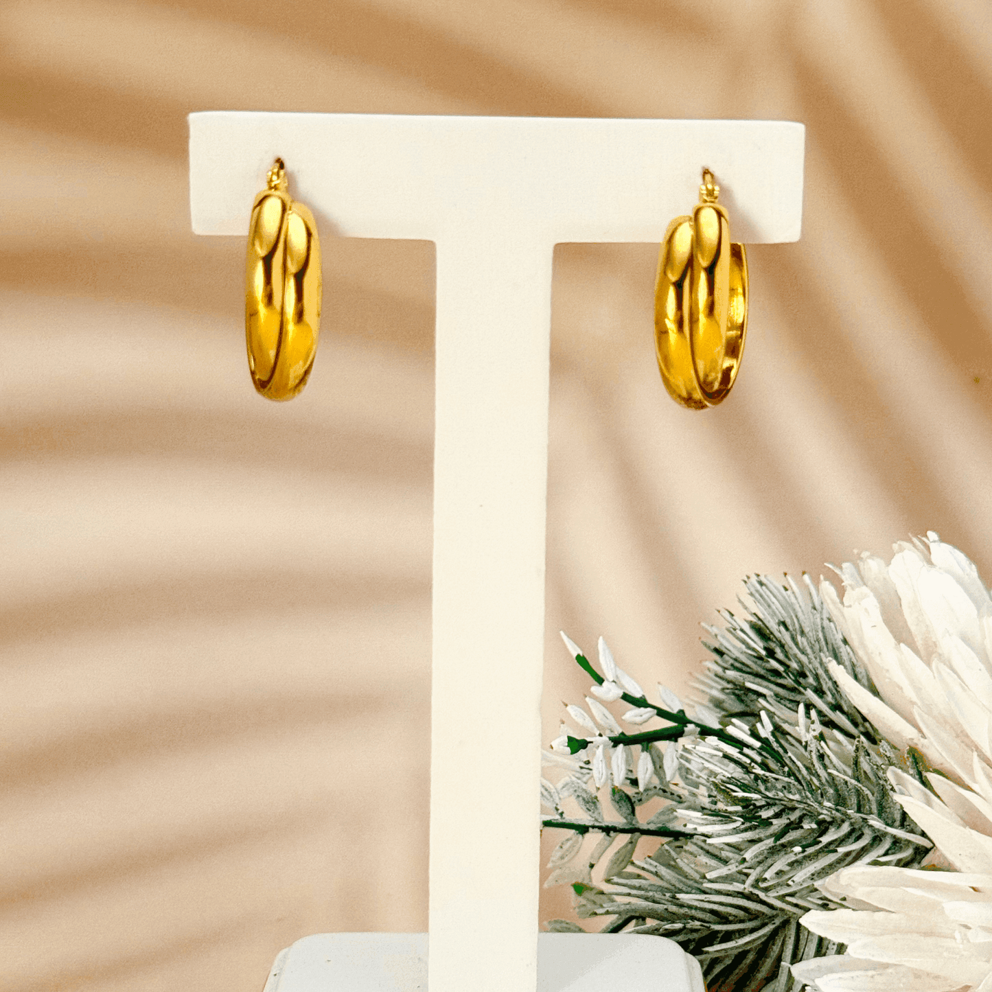 Gold interwoven dome hoop earrings with sculptural design and polished finish, stainless steel with PVD gold plating, minimalist waterproof jewellery.