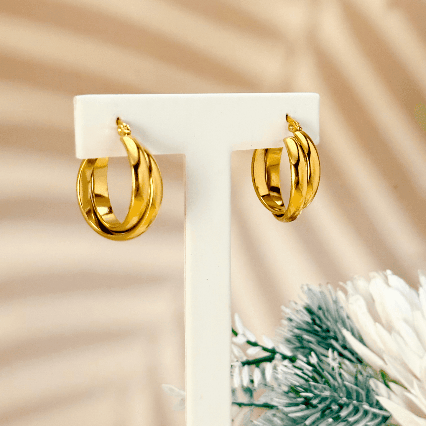 Gold interwoven dome hoop earrings with sculptural design and polished finish, stainless steel with PVD gold plating, minimalist waterproof jewellery.