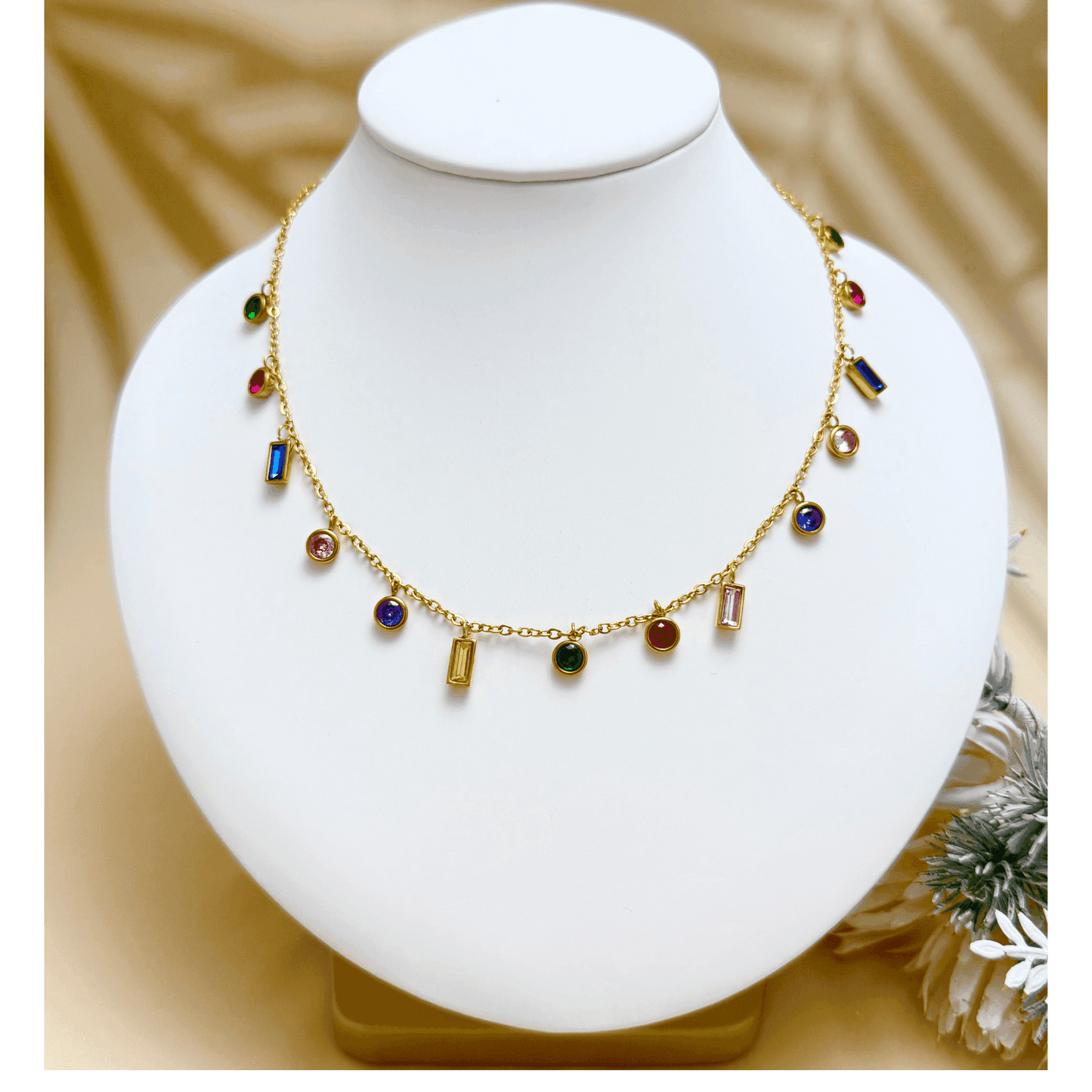 Gold multicolour zircon charm necklace with vibrant round and baguette zircon stones on a gold-plated stainless steel chain. Waterproof and hypoallergenic jewellery.