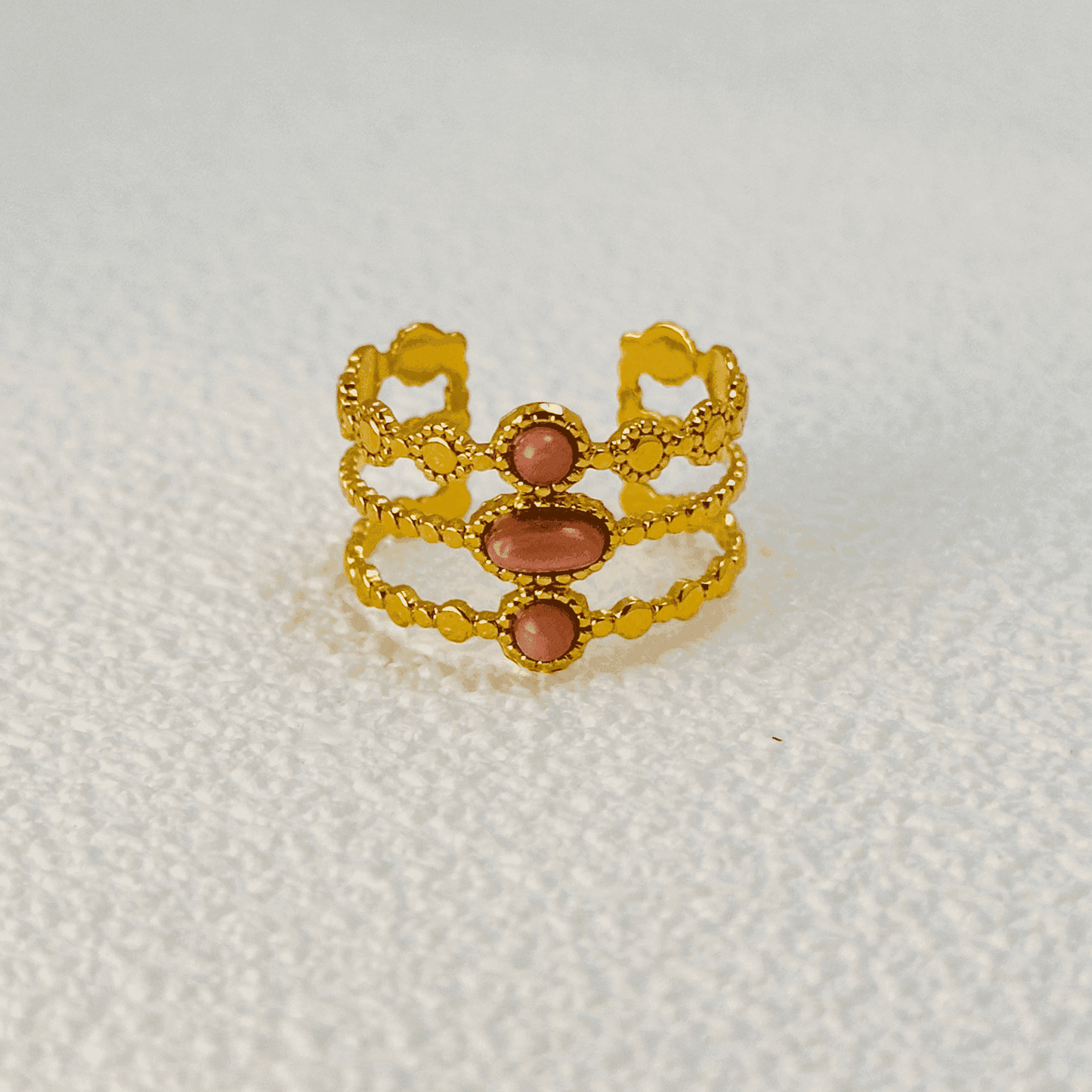 Boho-inspired gold-plated adjustable ring with a natural pink stone. Stackable, waterproof, and perfect for layering.