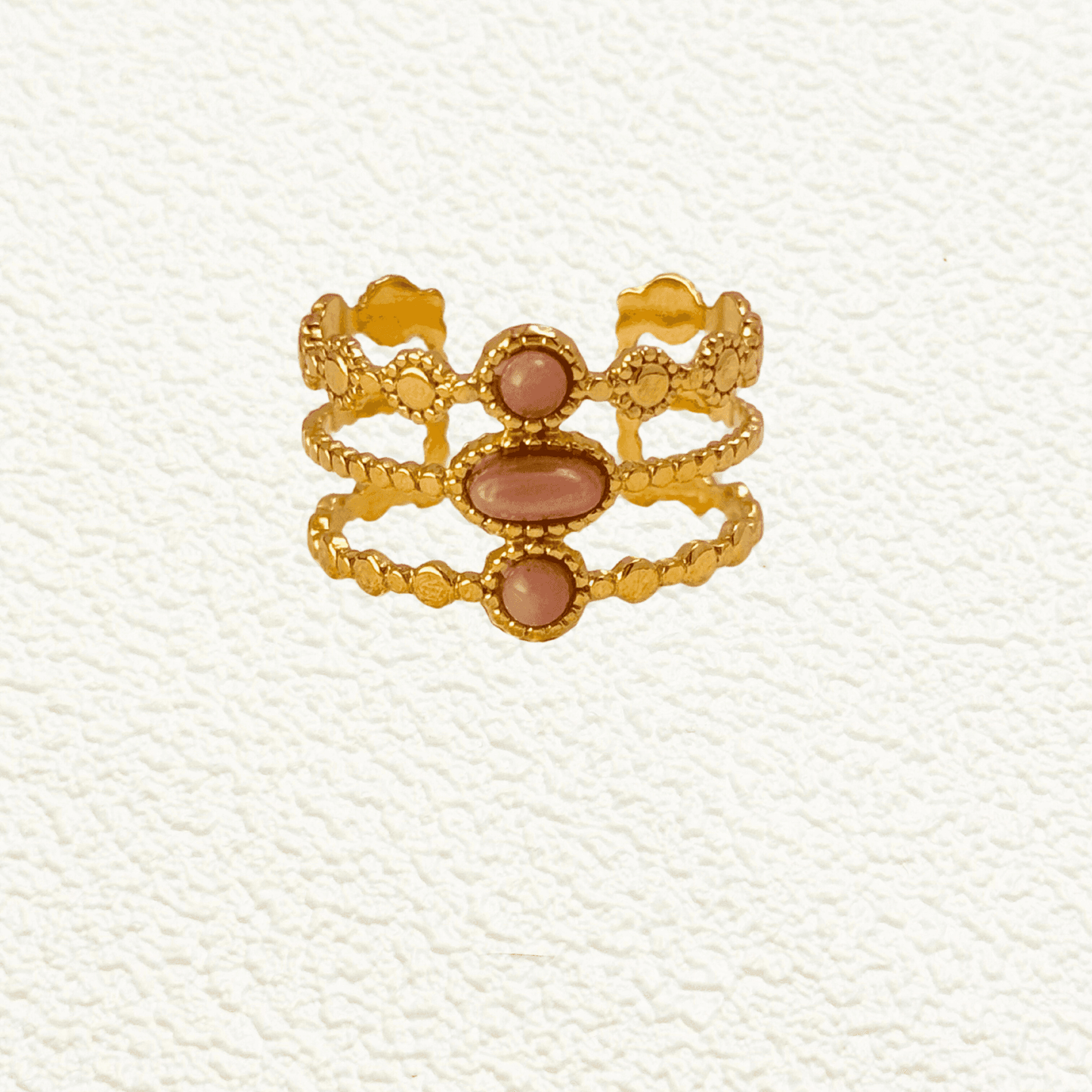 Boho-inspired gold-plated adjustable ring with a natural pink stone. Stackable, waterproof, and perfect for layering.
