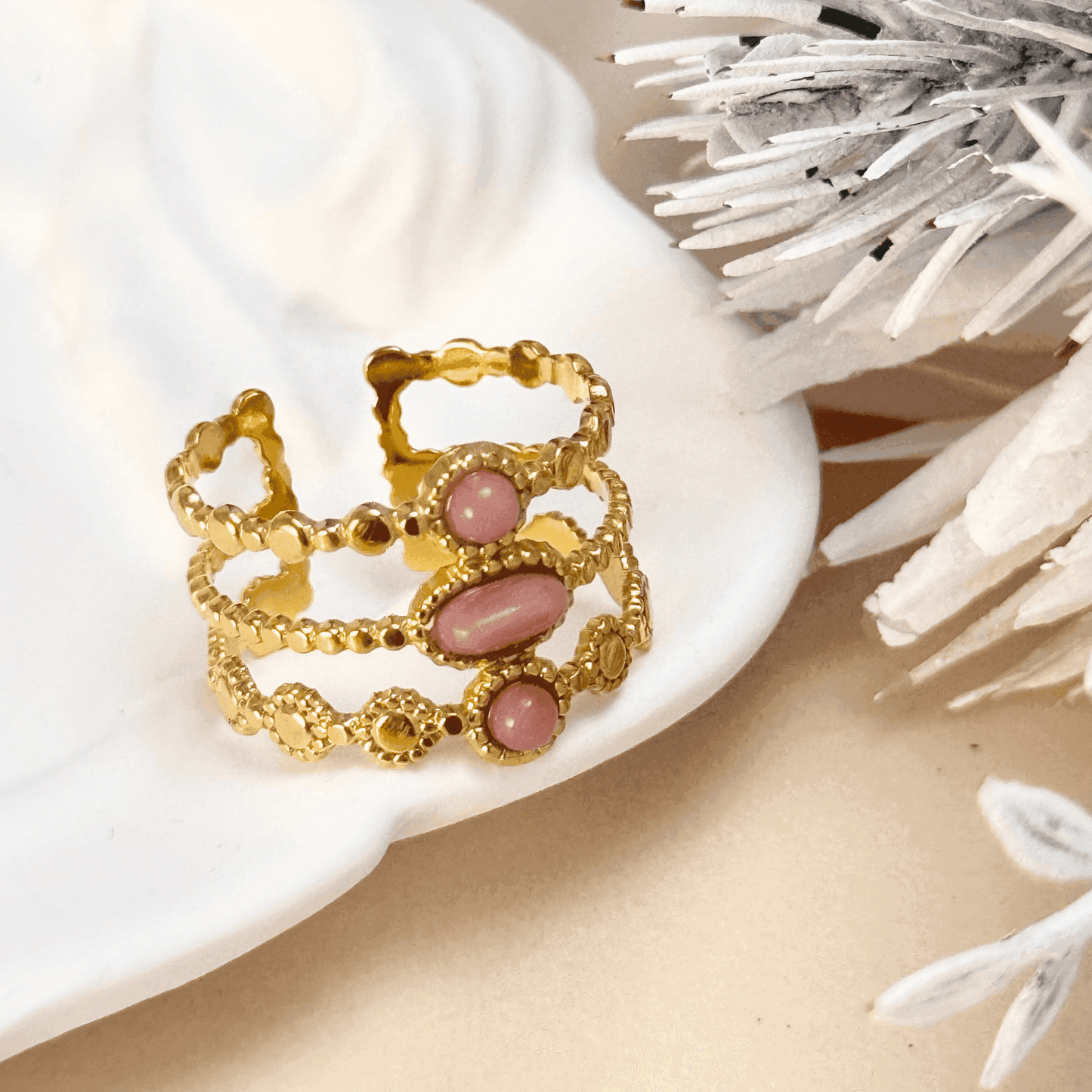 Boho-inspired gold-plated adjustable ring with a natural pink stone. Stackable, waterproof, and perfect for layering.