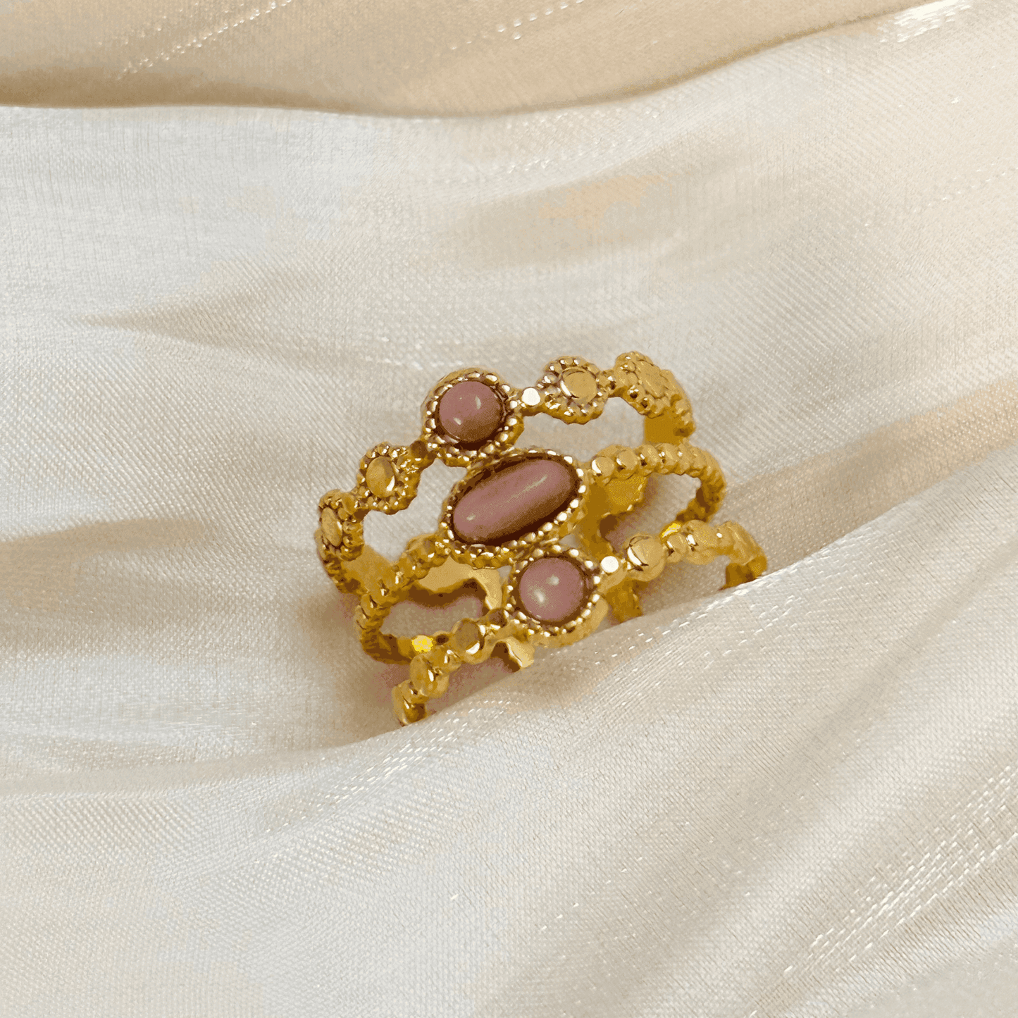 Boho-inspired gold-plated adjustable ring with a natural pink stone. Stackable, waterproof, and perfect for layering.