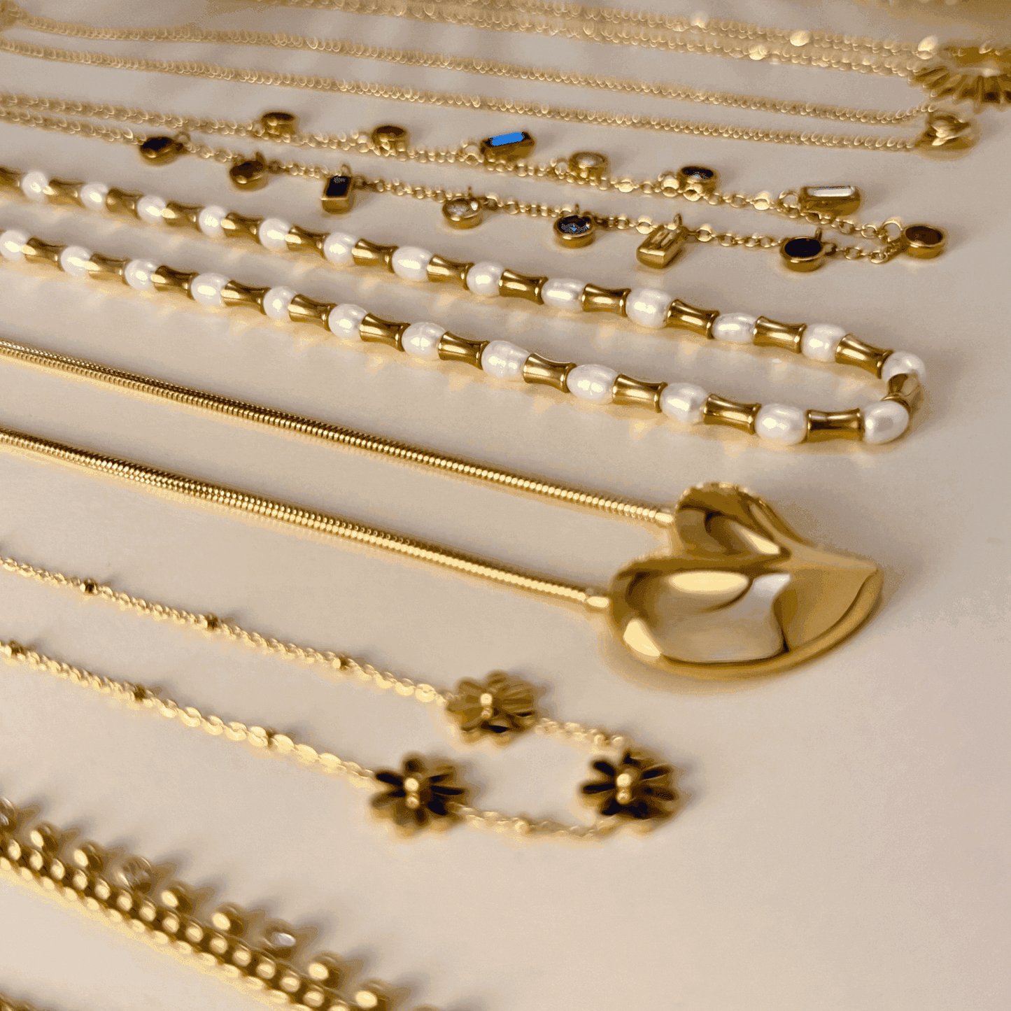 Gold Sculpted Heart Necklace, featuring a modern, asymmetrical heart pendant on a waterproof snake chain.