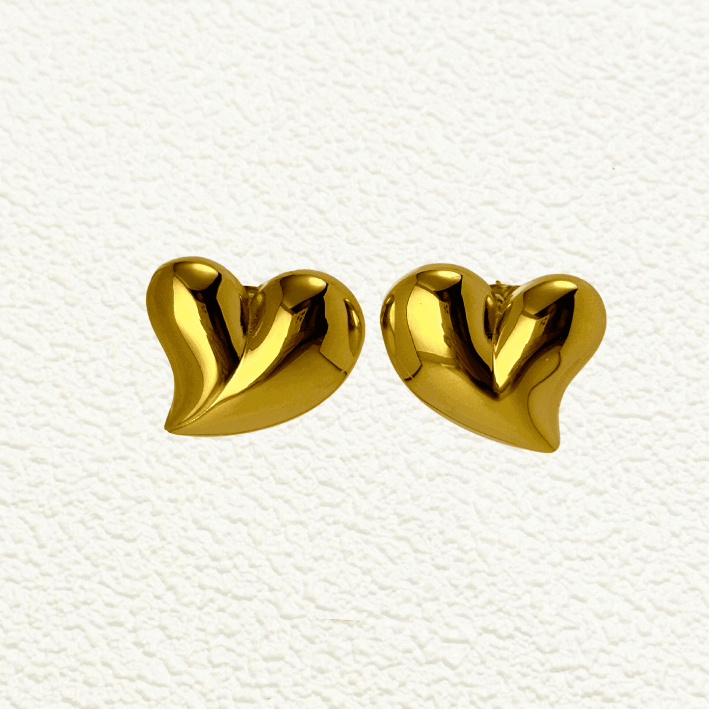 Discover the Valencia gold heart stud earrings, featuring a sculpted design with a high-polish finish. Waterproof, hypoallergenic & tarnish-resistant.