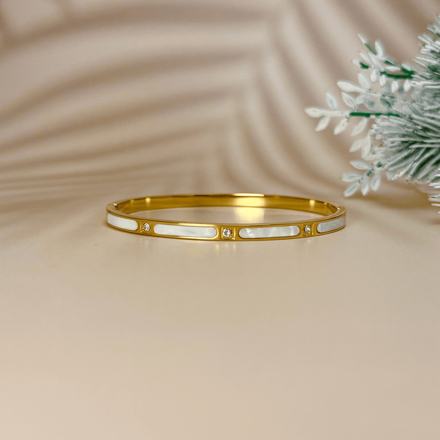 Gold shell inlay bangle with zircon stones, crafted from waterproof, tarnish-resistant stainless steel. Features a hinged clasp for secure fit, perfect for stacking or wearing alone.