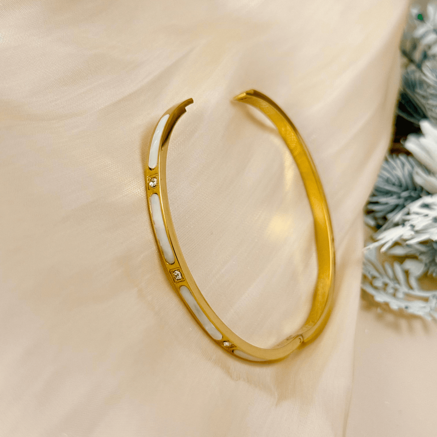 Gold shell inlay bangle with zircon stones, crafted from waterproof, tarnish-resistant stainless steel. Features a hinged clasp for secure fit, perfect for stacking or wearing alone.