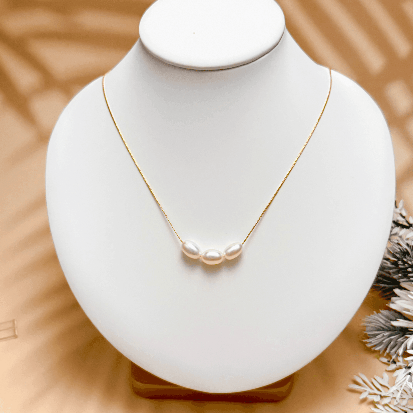 Gold and silver minimalist necklace with trio of 8–9 mm freshwater rice pearls, dainty and elegant for everyday wear or gifting.