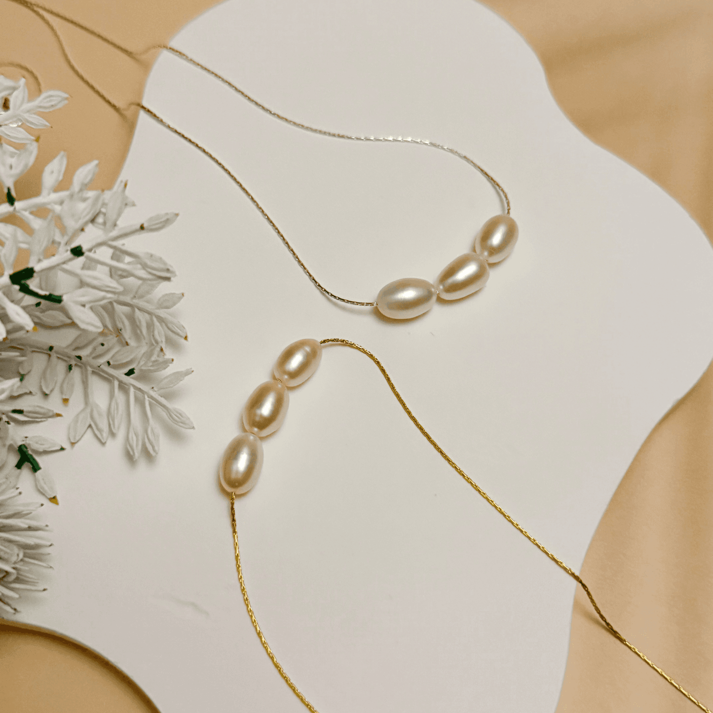 Gold and silver minimalist necklace with trio of 8–9 mm freshwater rice pearls, dainty and elegant for everyday wear or gifting.