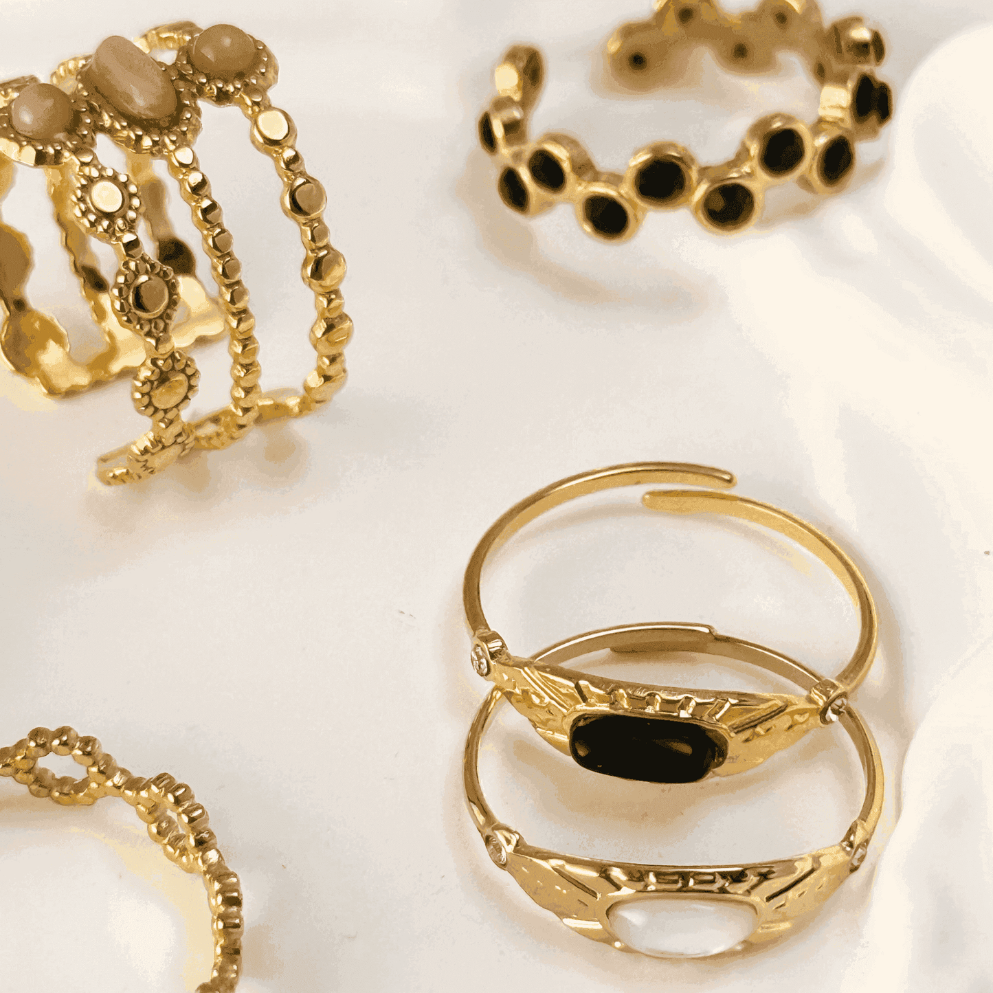Gold stacking adjustable rings featuring natural stones and intricate boho designs. Waterproof and stylish, perfect for layering and everyday wear.