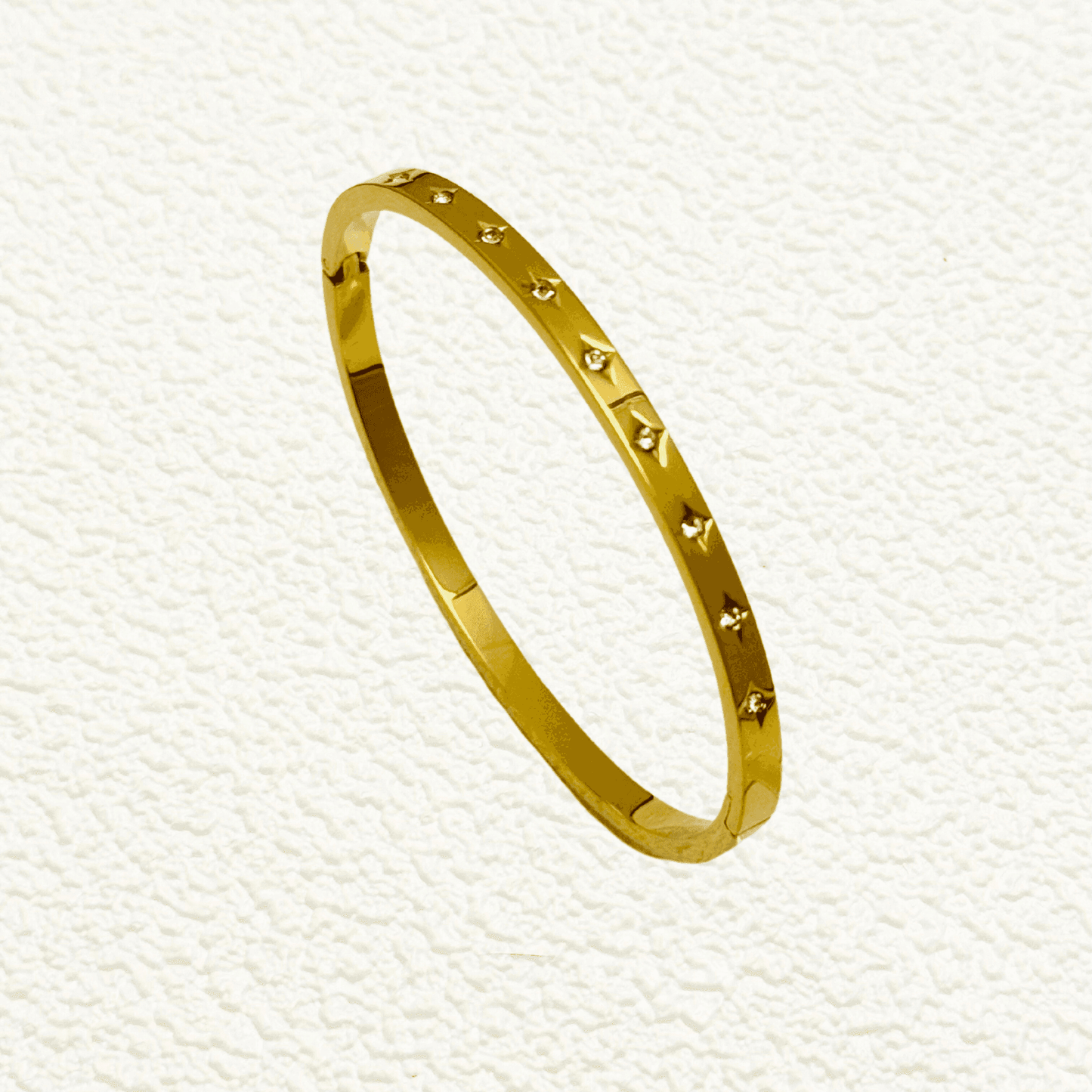 Minimalist gold starry zircon bangle featuring delicate star engravings and high-quality zircon stones, waterproof and hypoallergenic.