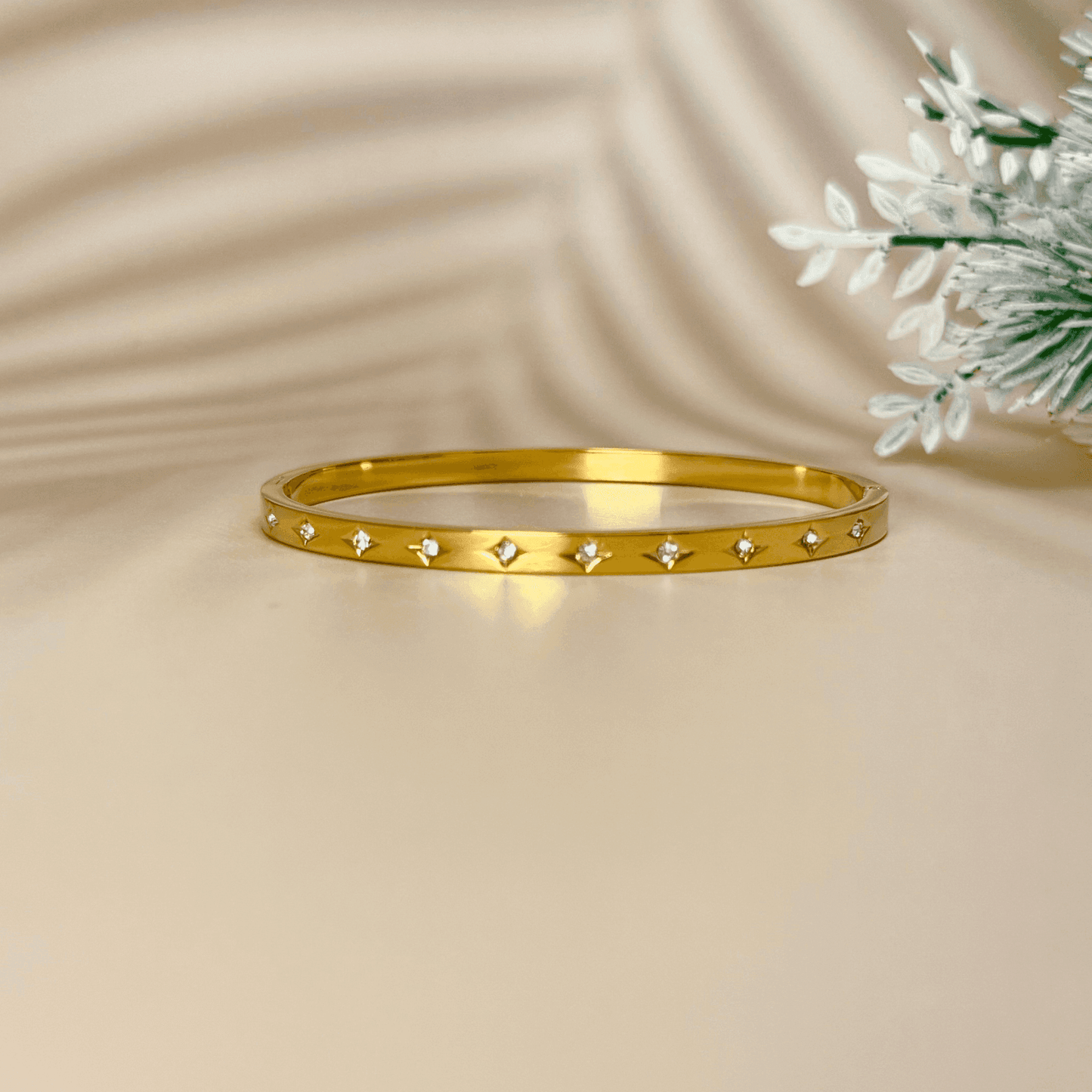 Minimalist gold starry zircon bangle featuring delicate star engravings and high-quality zircon stones, waterproof and hypoallergenic.