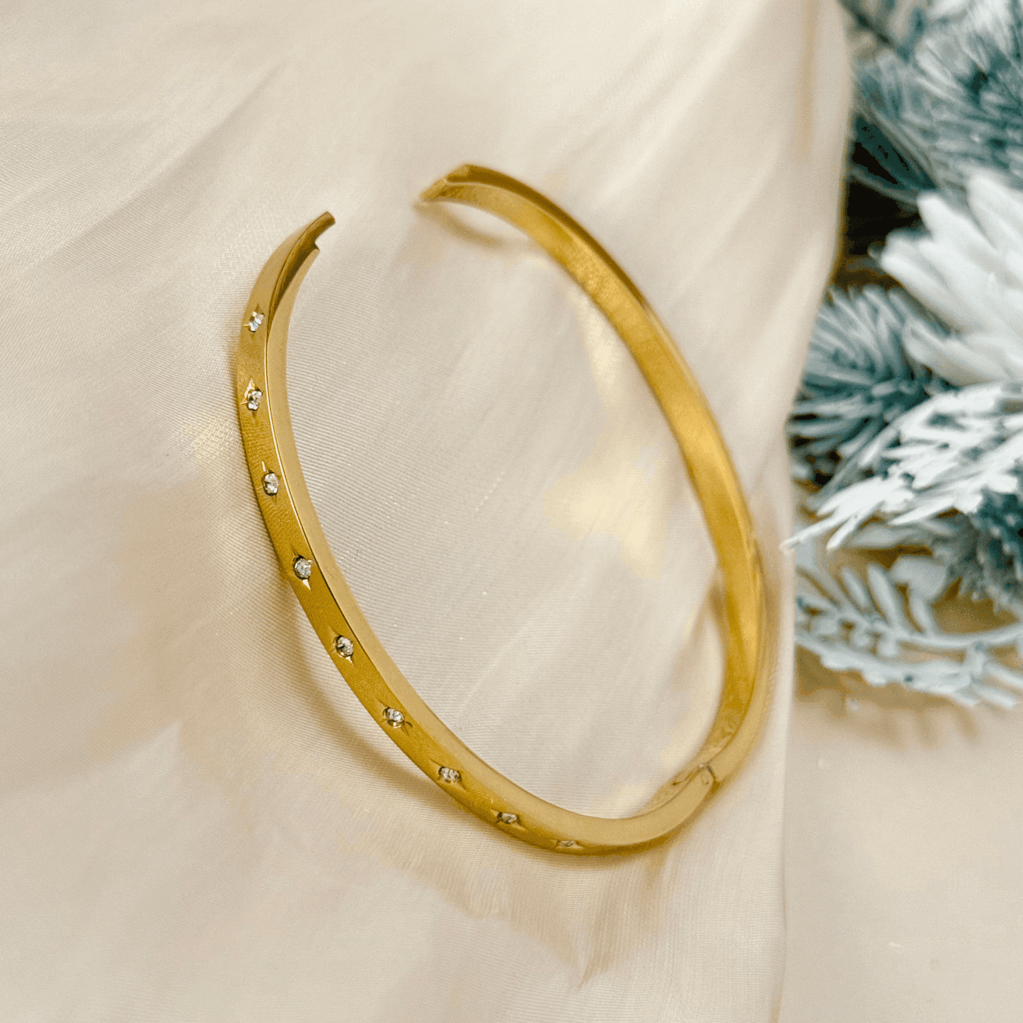 Minimalist gold starry zircon bangle featuring delicate star engravings and high-quality zircon stones, waterproof and hypoallergenic.