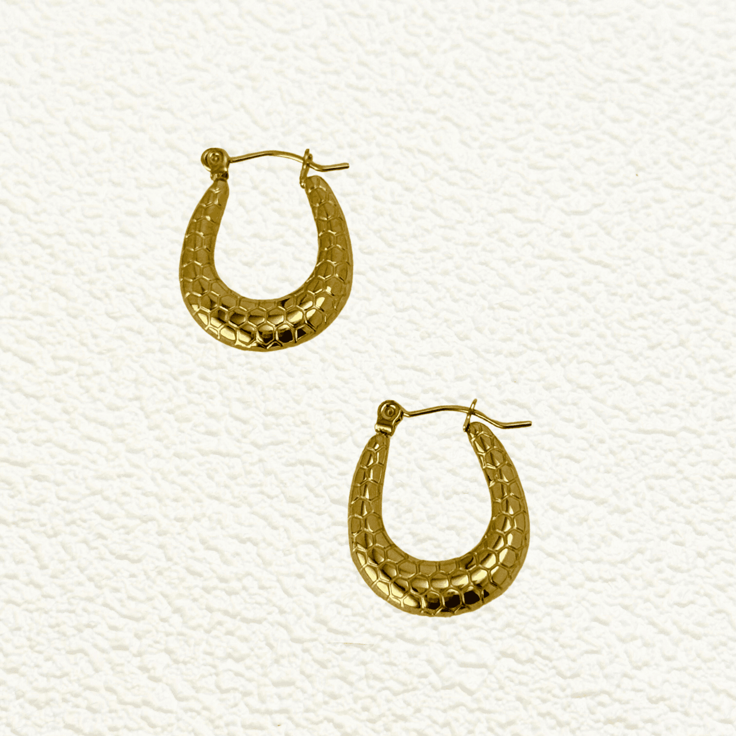 Gold textured hoop earrings with a honeycomb pattern, waterproof and hypoallergenic. Perfect for everyday wear and layering.
